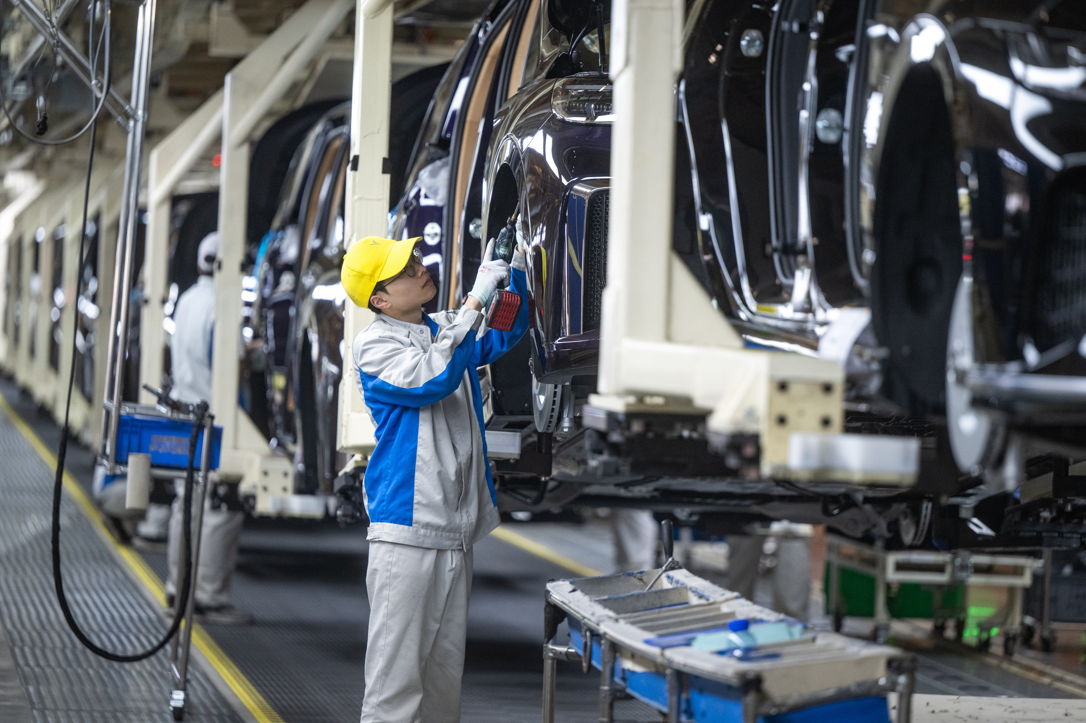 Workers are seen at an assembly line of Voyah, a Chinese luxury electric auto brand, in Wuhan on Monday. Photo: Xinhua