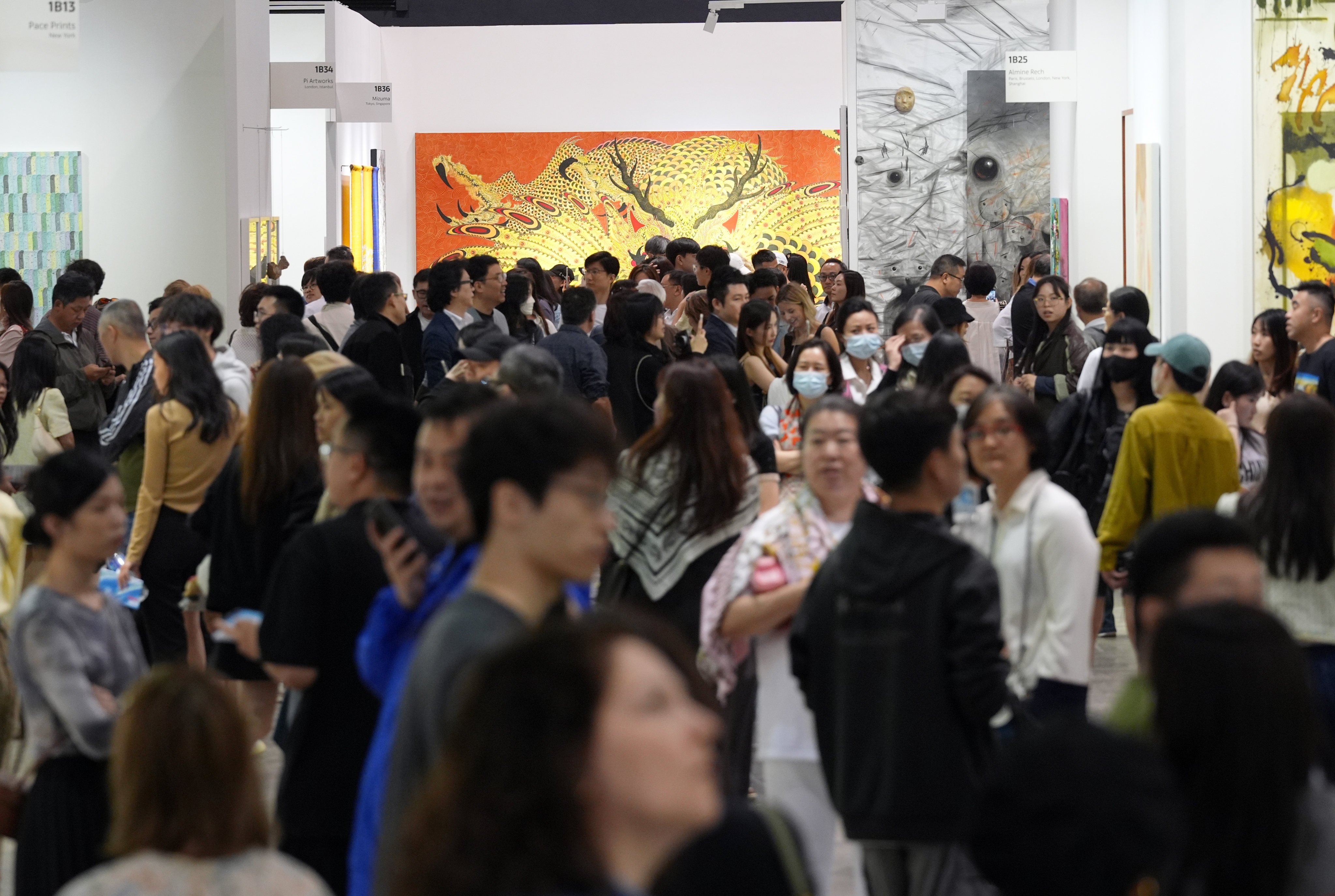 Visitors admire artworks at Art Basel Hong Kong, the highlight of Art Week in the city, as the contemporary art fair opens for public visitors at the Hong Kong Convention and Exhibition Centre in Wan Chai. Photo: Eugene Lee