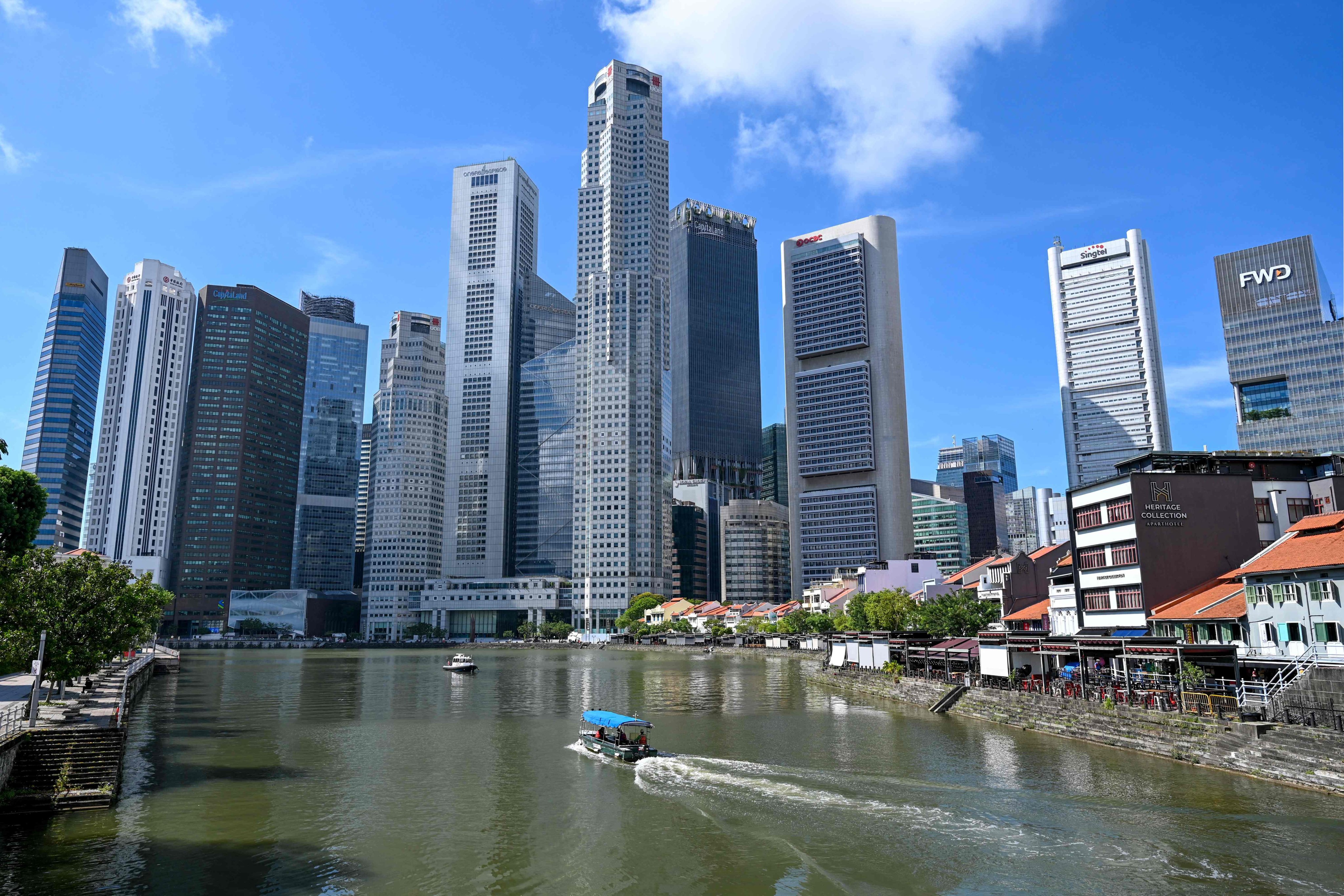 A boat cruises on the water in the central financial business district area in Singapore. The investigation prompted authorities to set up an interministerial panel to review anti-money-laundering measures and inspect financial institutions suspected of involvement. Photo: AFP