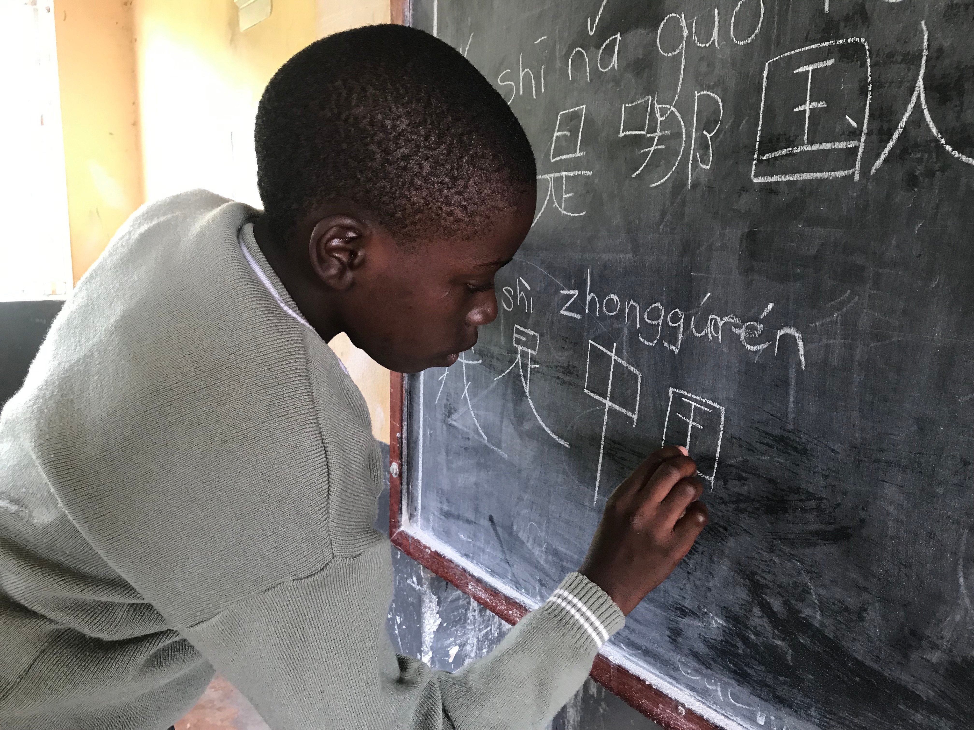 A high-schooler in Uganda learning Mandarin in school on September 29, 2019. Africa has yet to translate its huge and growing population into human capital. China is uniquely qualified to help. Photo: Shutterstock