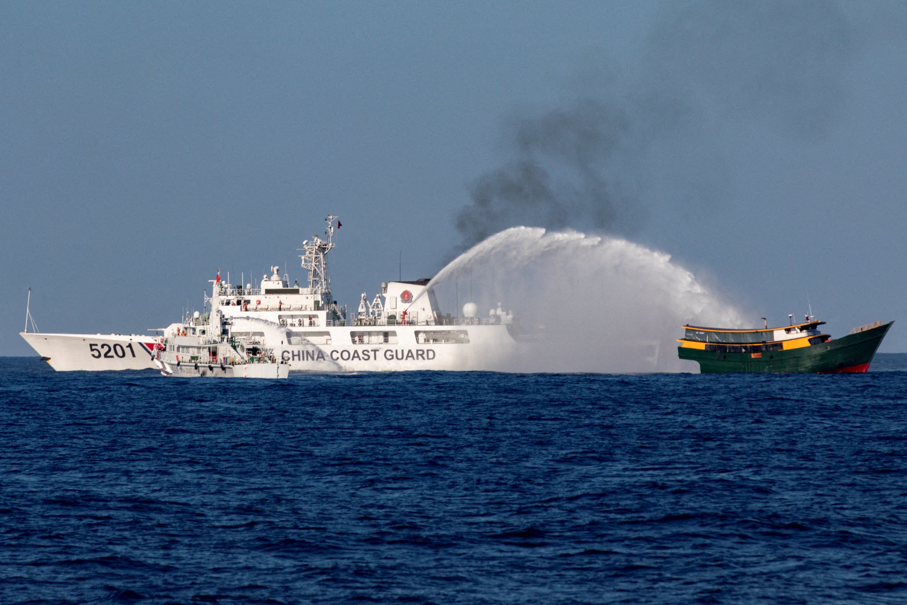 Chinese Coast Guard vessels fire water cannons towards a Philippine resupply vessel Unaizah May 4 on its way to a resupply mission at Second Thomas Shoal in the South China Sea on March 5. Photo: Reuters
