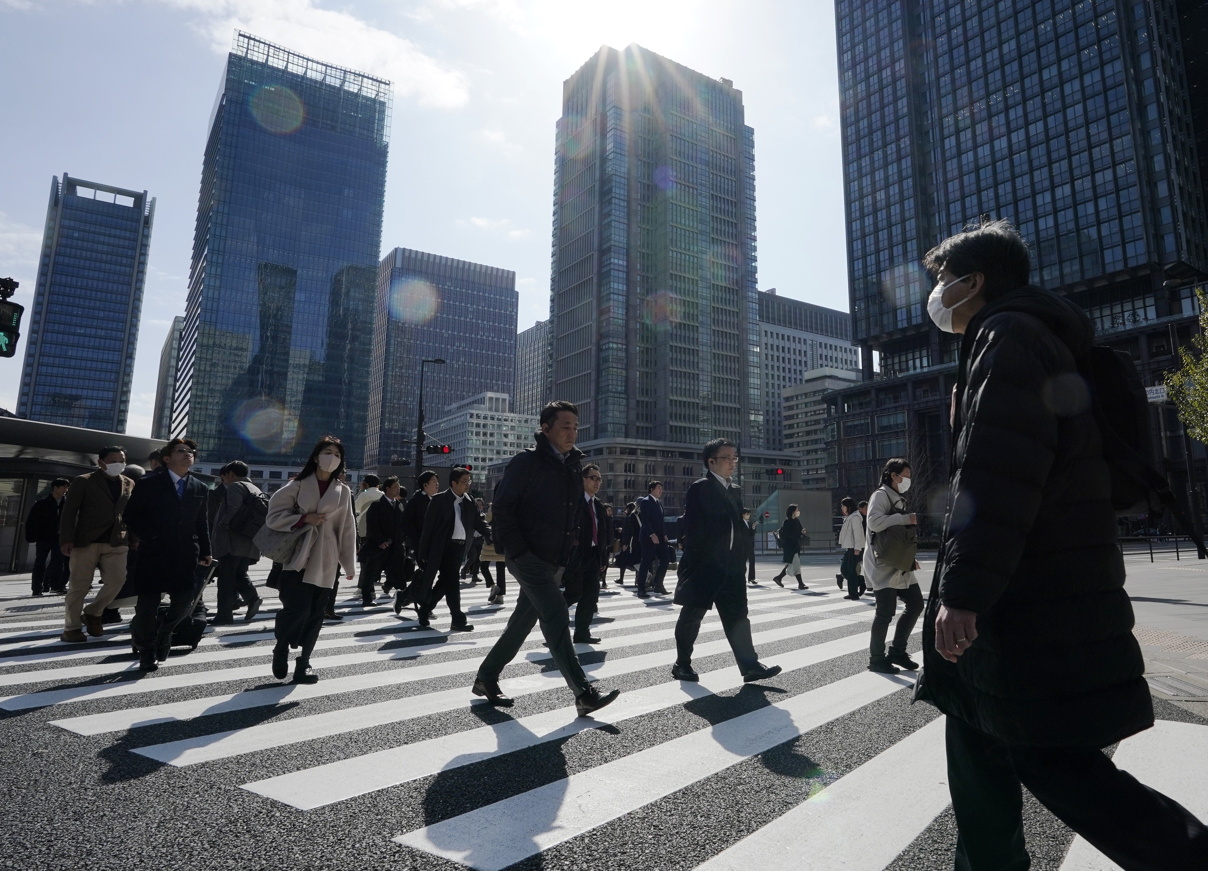 People walk in a crosswalk in Tokyo on March 7, 2024. Photo: EPA-EFE