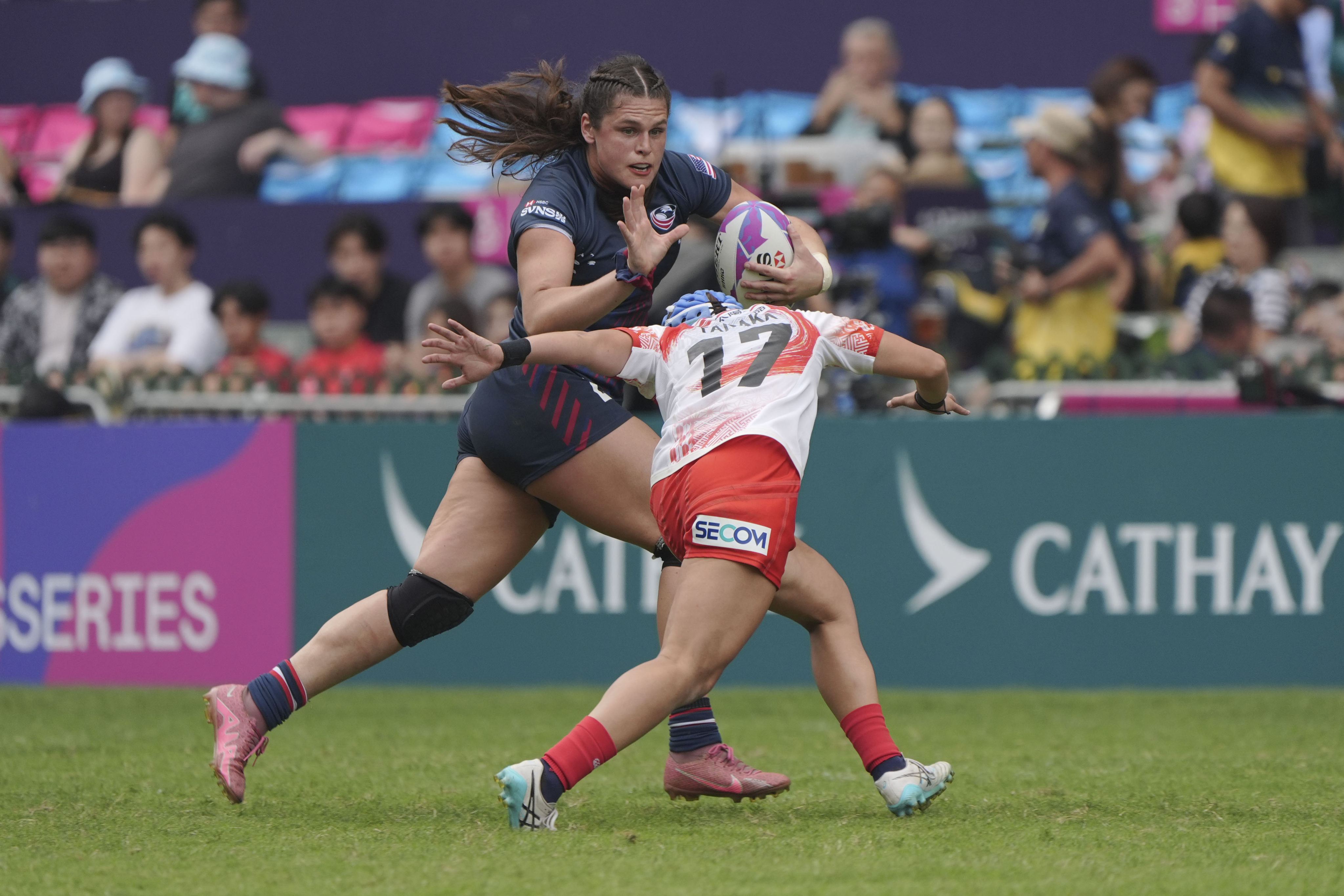 The USA’s Ilona Maher fends off Japan’s Emii Tanaka during the Americans’ 17-12 win on day one of the Sevens on Friday. Photo: Eugene Lee