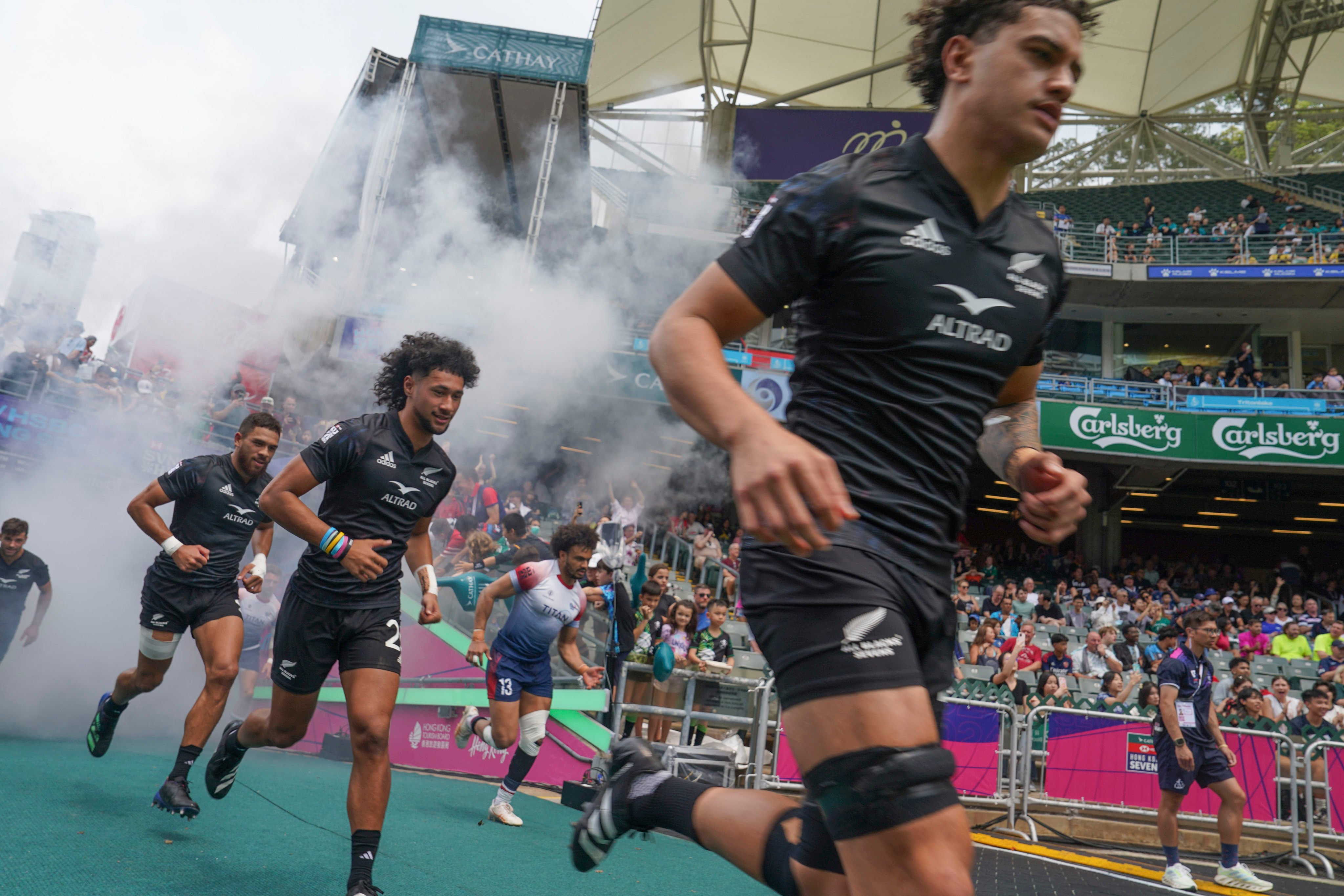 New Zealand’s men run onto the field for their game against Great Britain on the first day of the Cathay/HSBC Hong Kong Sevens. Photo: Elson Li