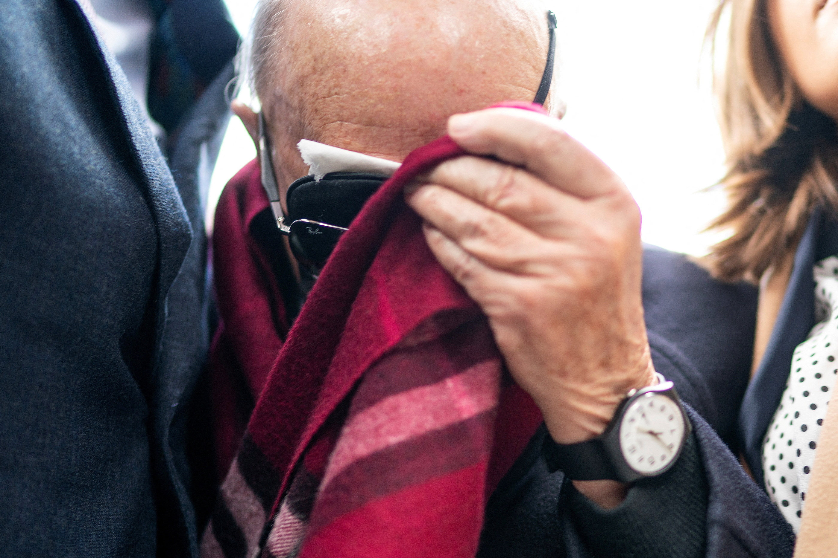 British billionaire Joe Lewis hides his face with a scarf as he arrives at court in New York for sentencing on Thursday. Photo: Reuters