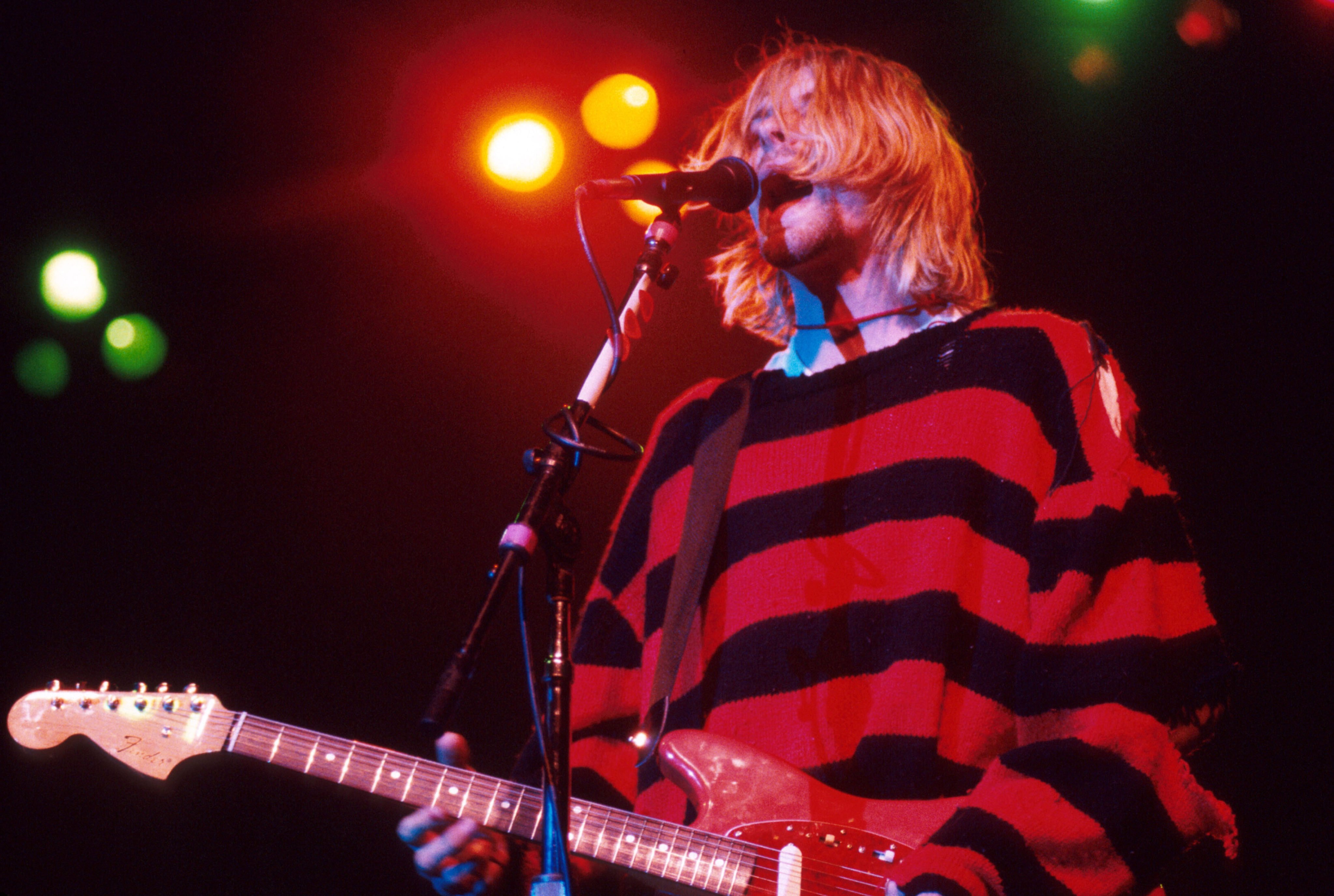 Nirvana frontman Kurt Cobain became a ’90s style icon with outfits from oversized cardigans to bug-eye shades, and his grunge fashion influence lives on 30 years after his death as much as his music. Photo: Getty Images