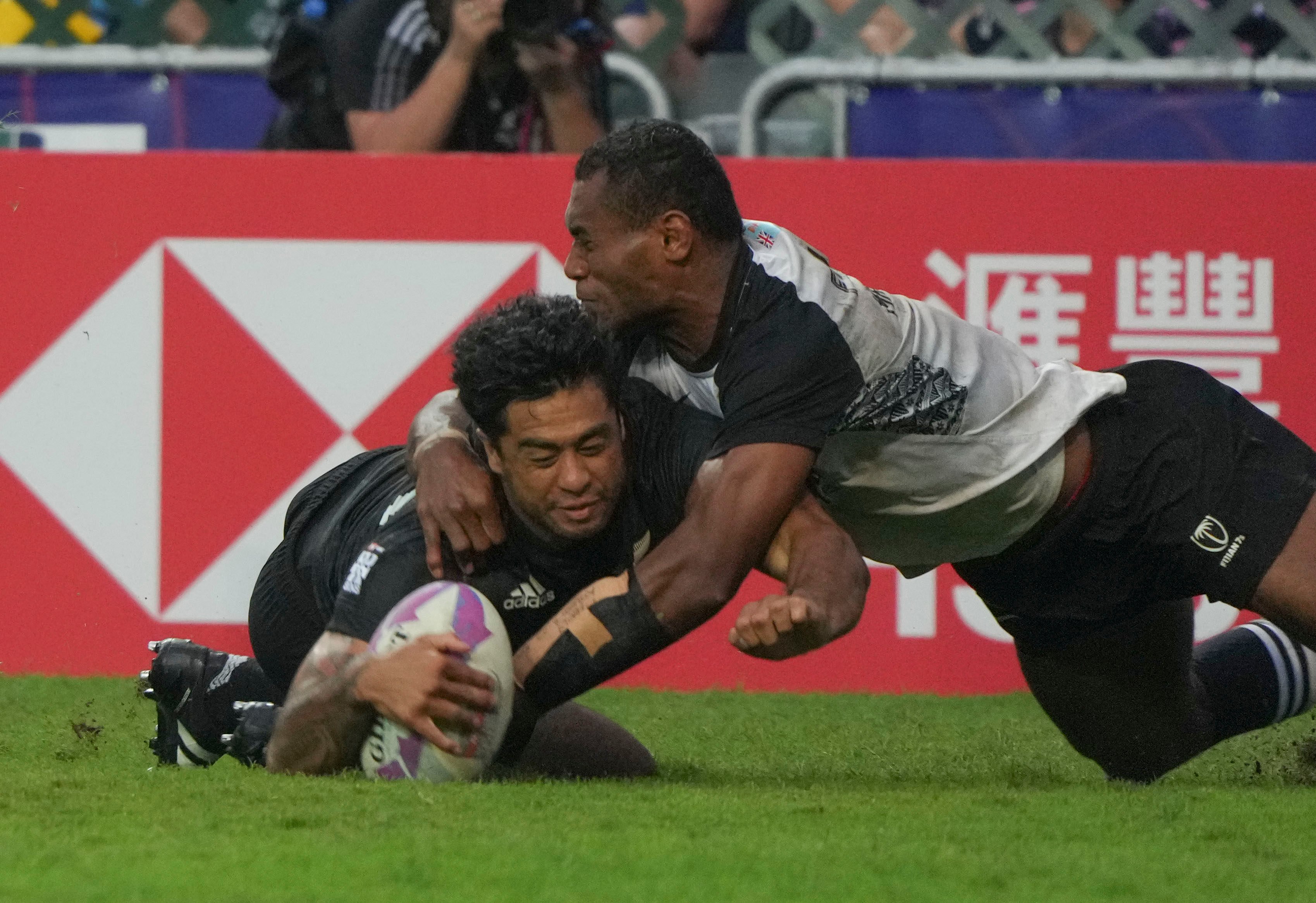 New Zealand’s Regan Ware scores a try despite the attentions of Fiji’s Filipe Sauturaga. Photo: Sam Tsang