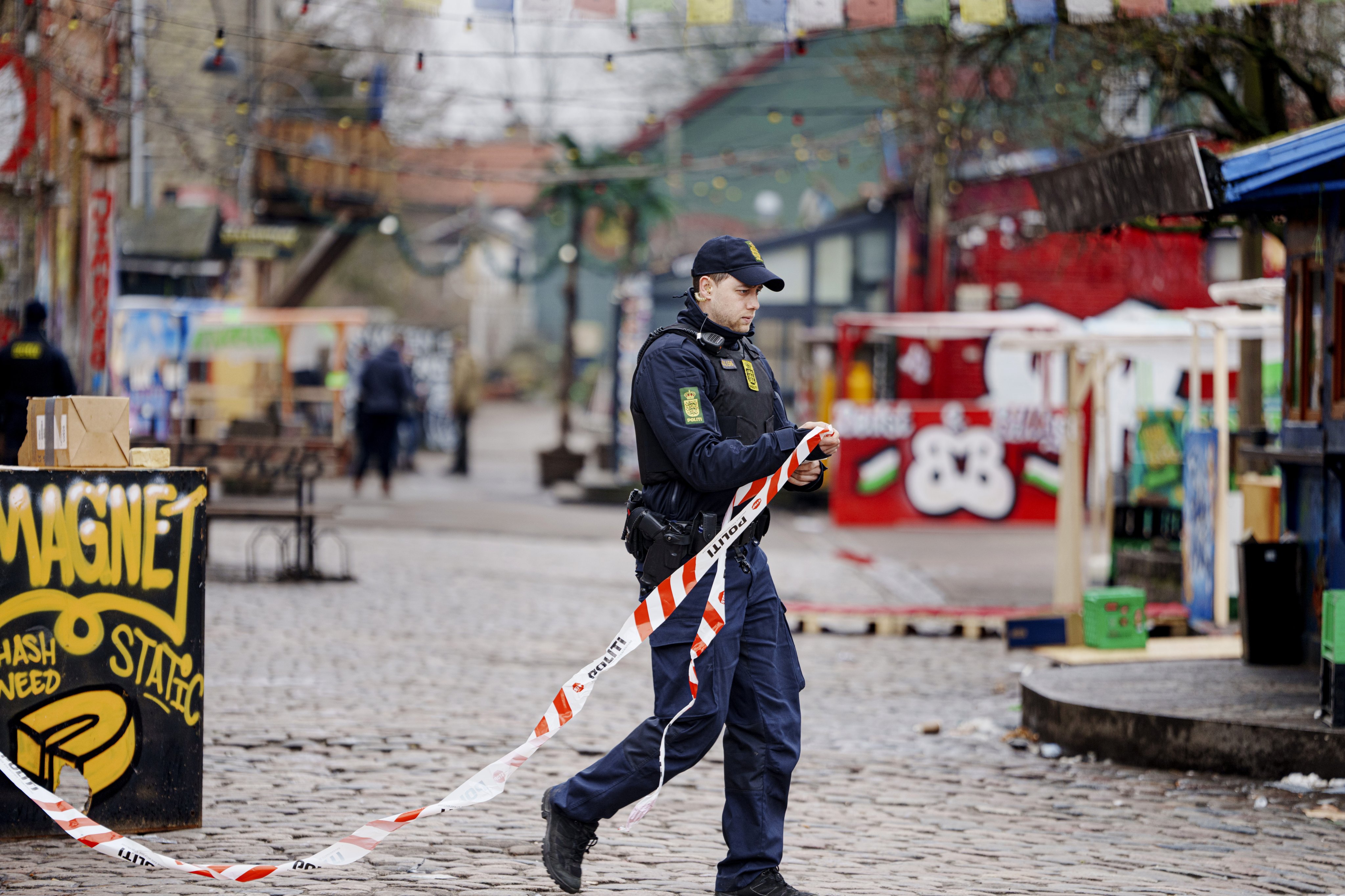 A police officer cordons off an area as part of closing down Pusher Street. Photo: EPA-EFE