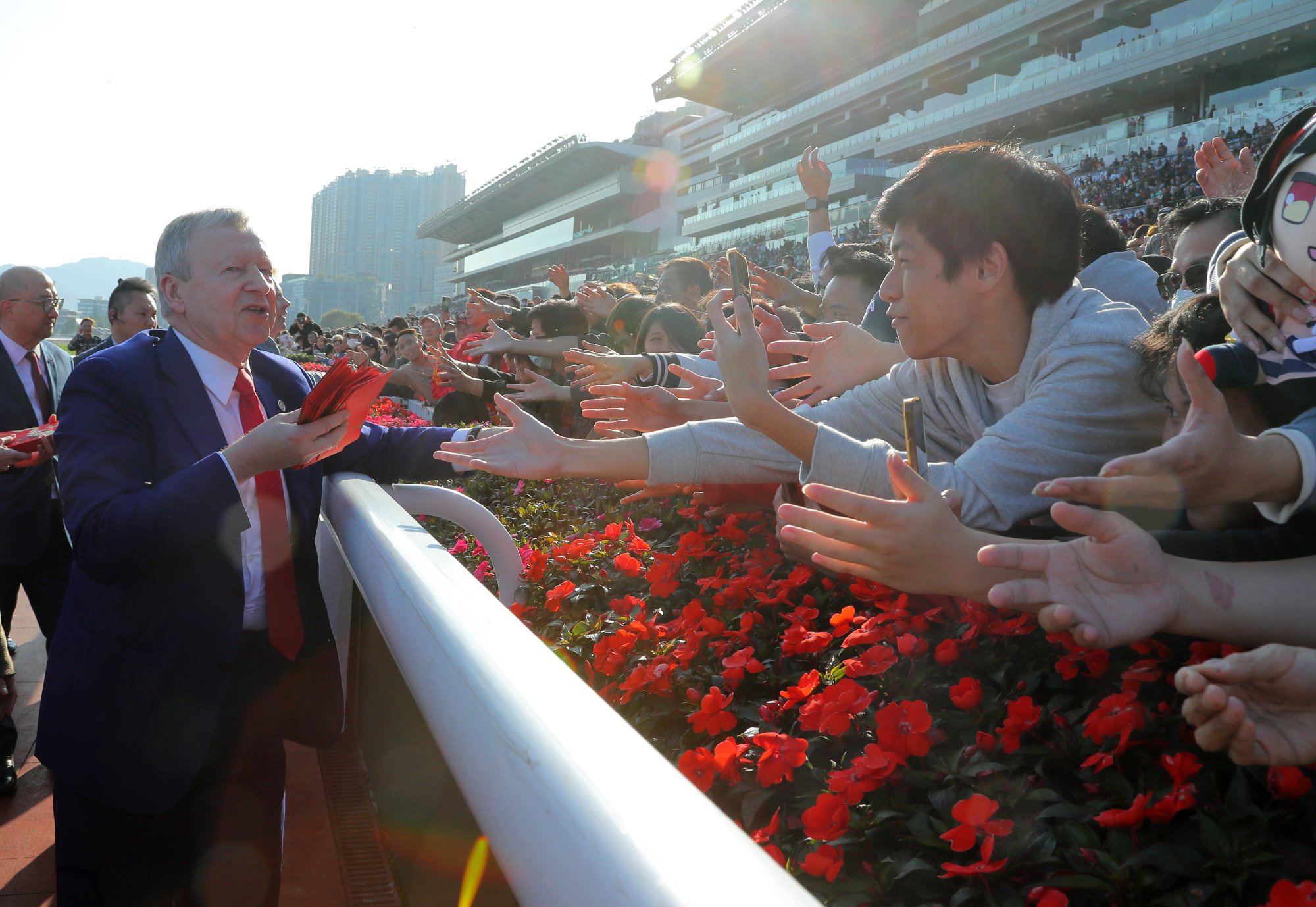 Jockey Club chief executive Winfried Engelbrecht-Bresges greets fans at Sha Tin racecourse during the Chinese New Year race day.