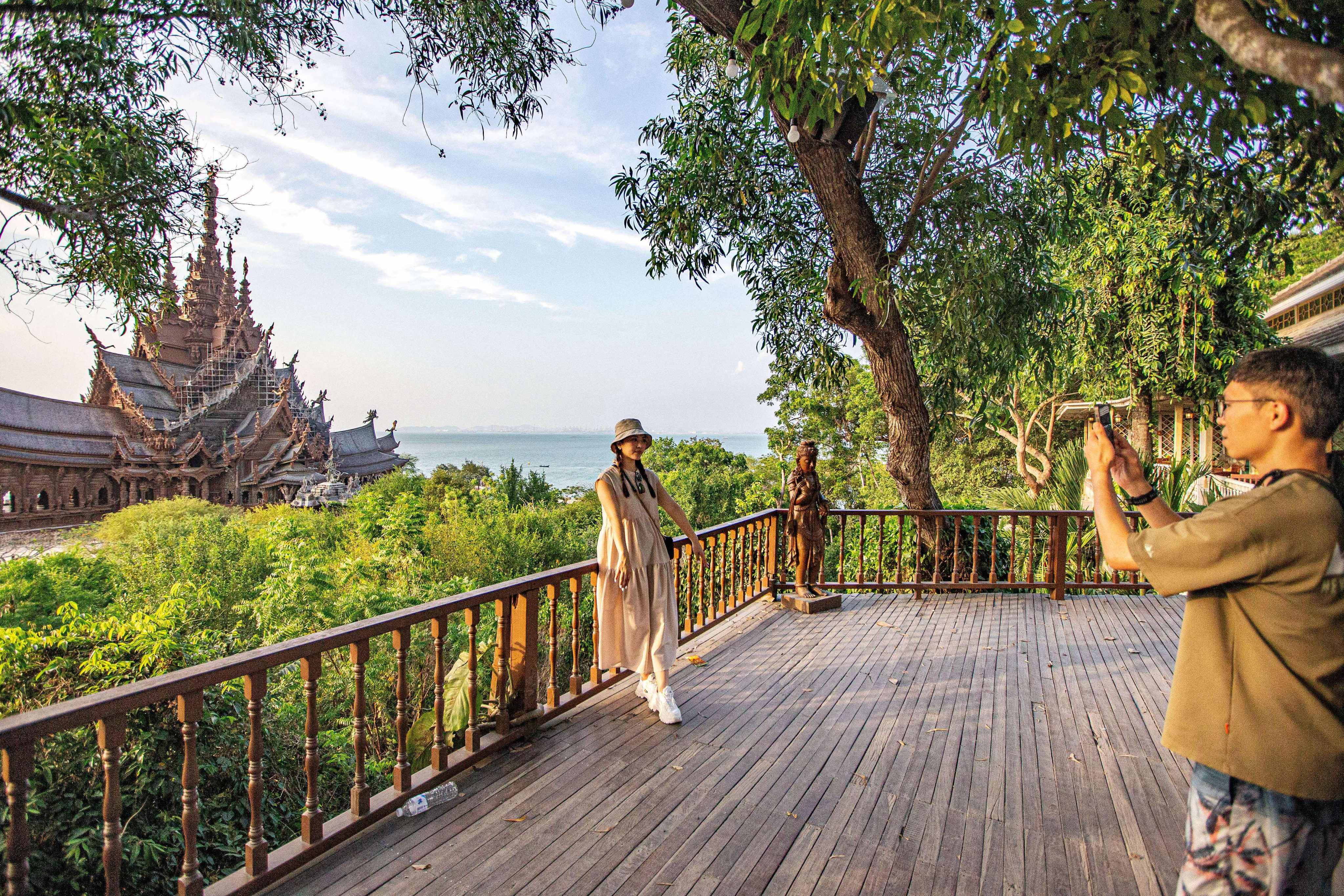 Tourists take photos at the Sanctuary of Truth Museum in Pattaya, Thailand. Tourism-reliant Thailand has set a goal of attracting 80 million foreign visitors by 2027. Photo: Xinhua