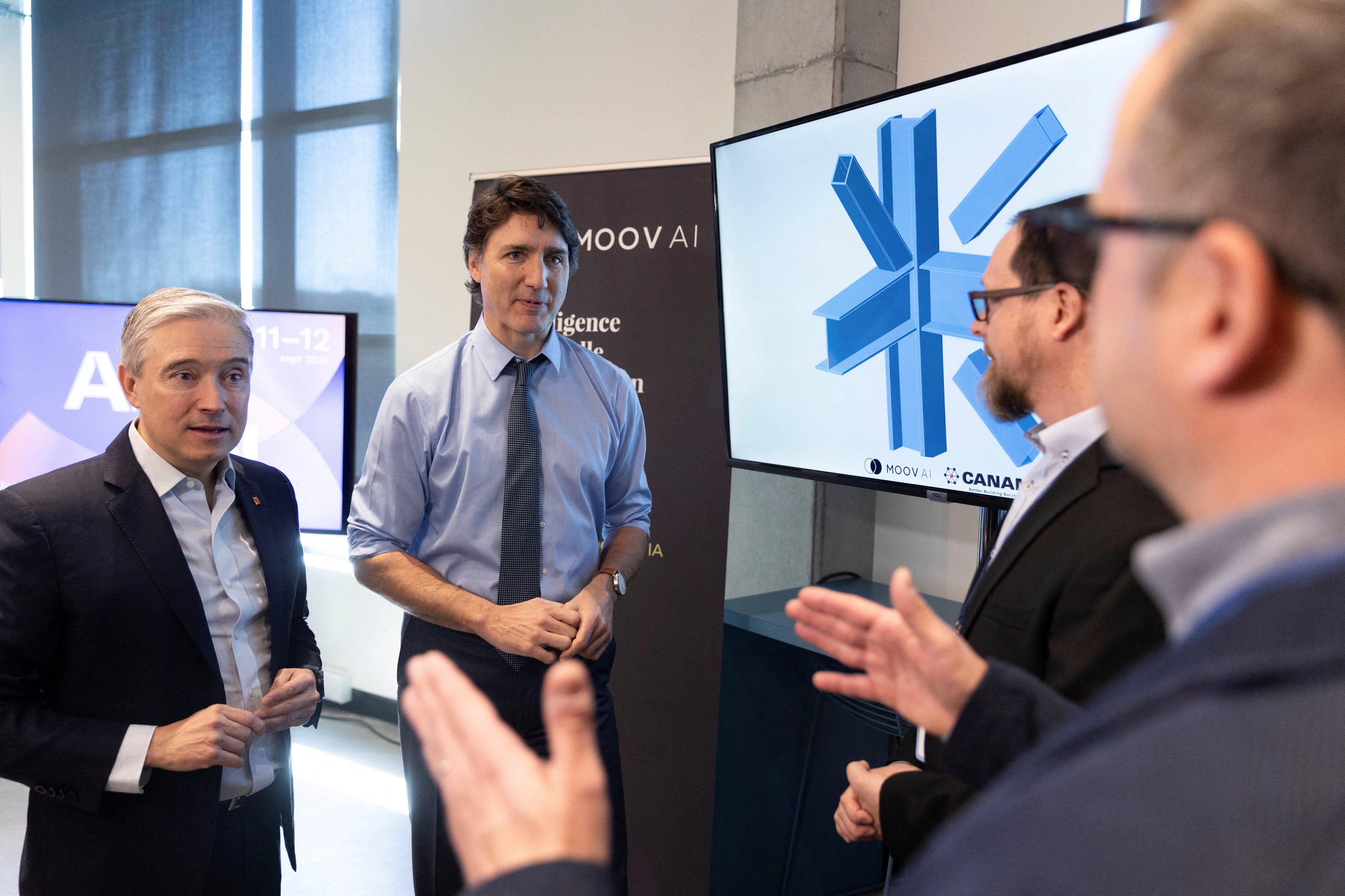 Canada’s Minister of Innovation, Science and Industry, Francois-Philippe Champagne and Prime Minister Justin Trudeau meet Dominic Danis of Moov AI and Patrick Martin of Canam during a visit to the Scale AI offices in Montreal, Quebec on Sunday. Photo: Reuters 