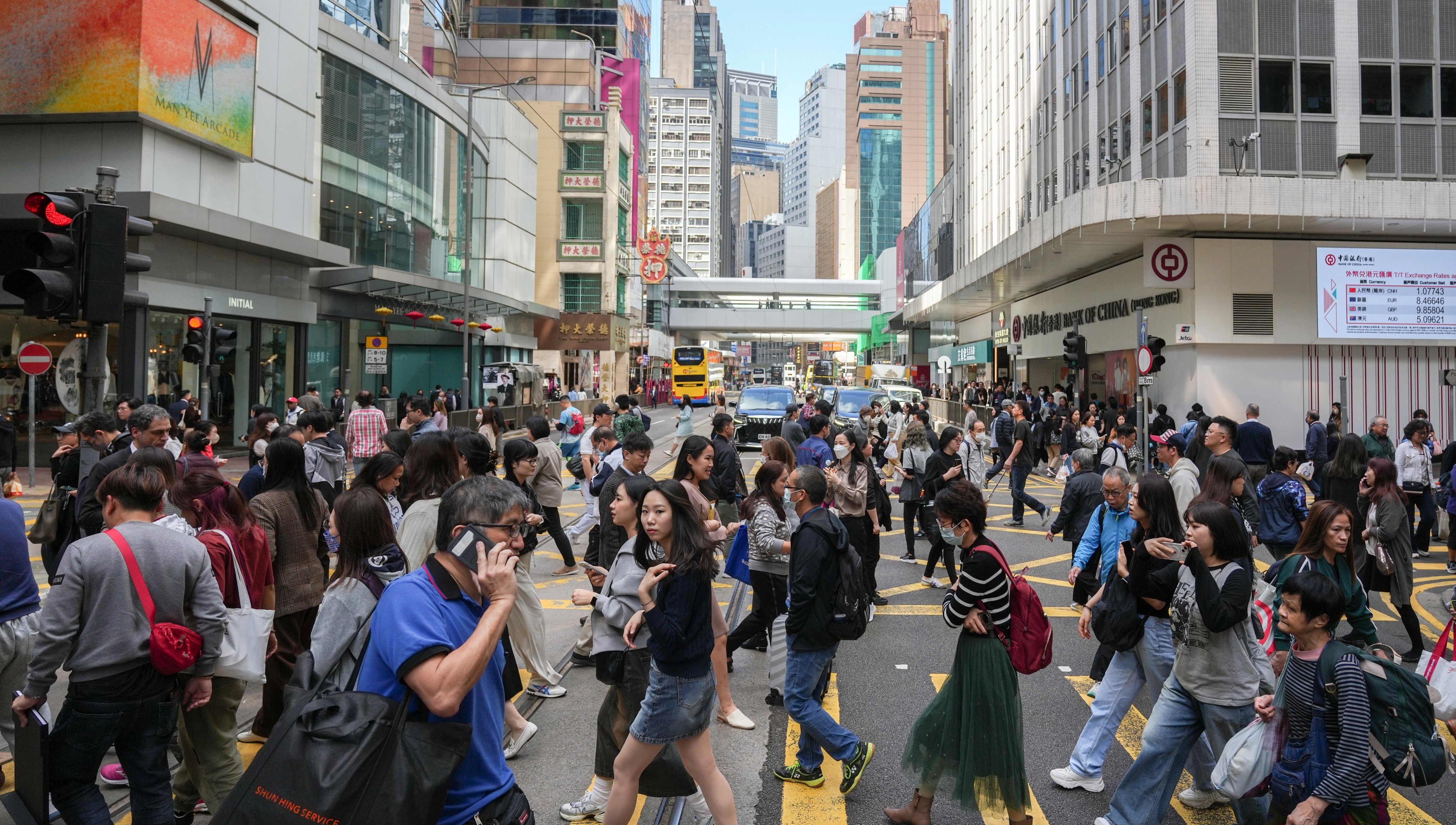 Hongkongers cross a street in Central on January 18, 2024. Photo: Eugene Lee
