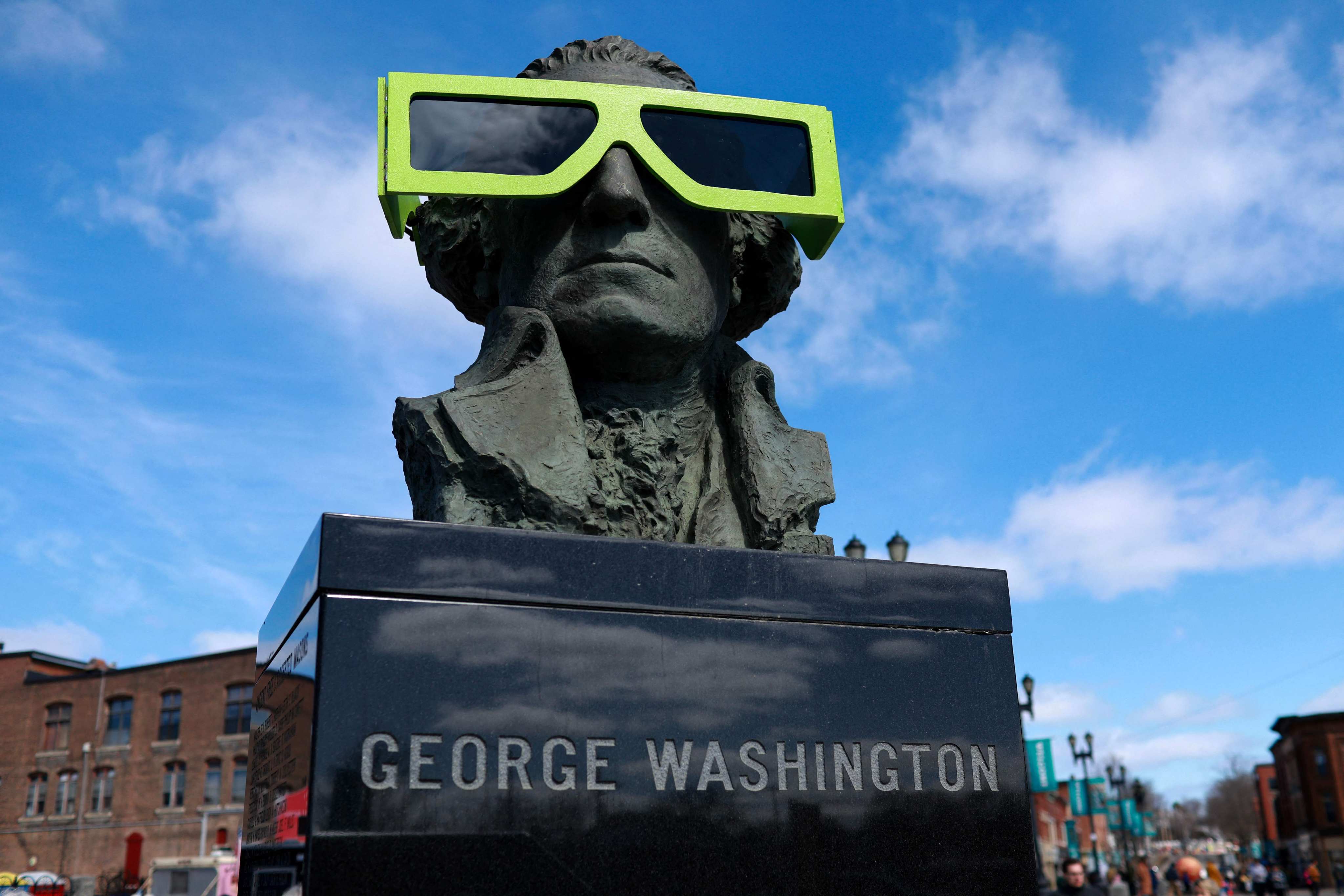 Eclipse glasses on a statue of George Washington, in Houlton, Maine. Photo: AFP