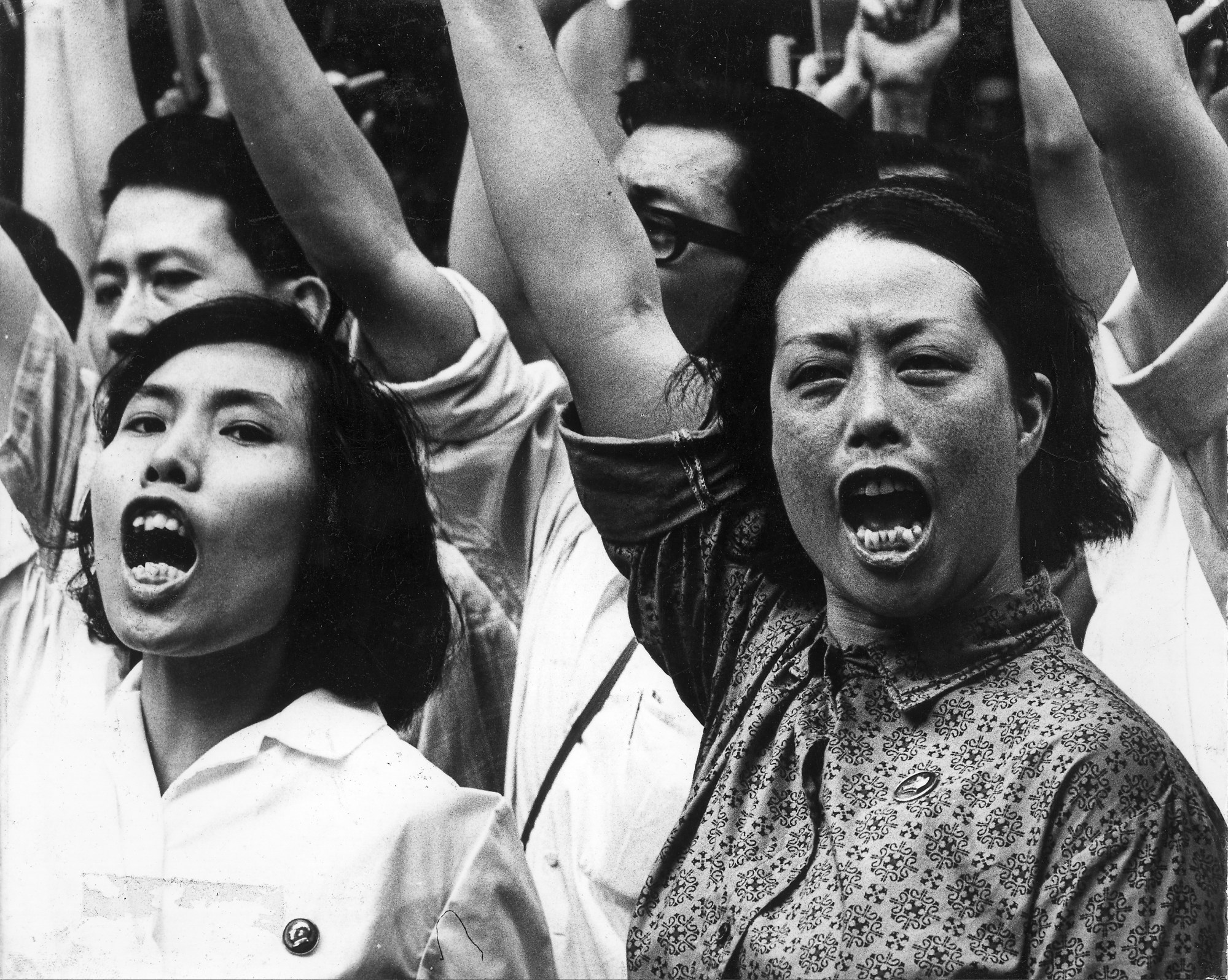 Protesters, with Mao badges pinned to their chests, shout revolutionary slogans outside Government House in 1967. Photo: Chan Kiu