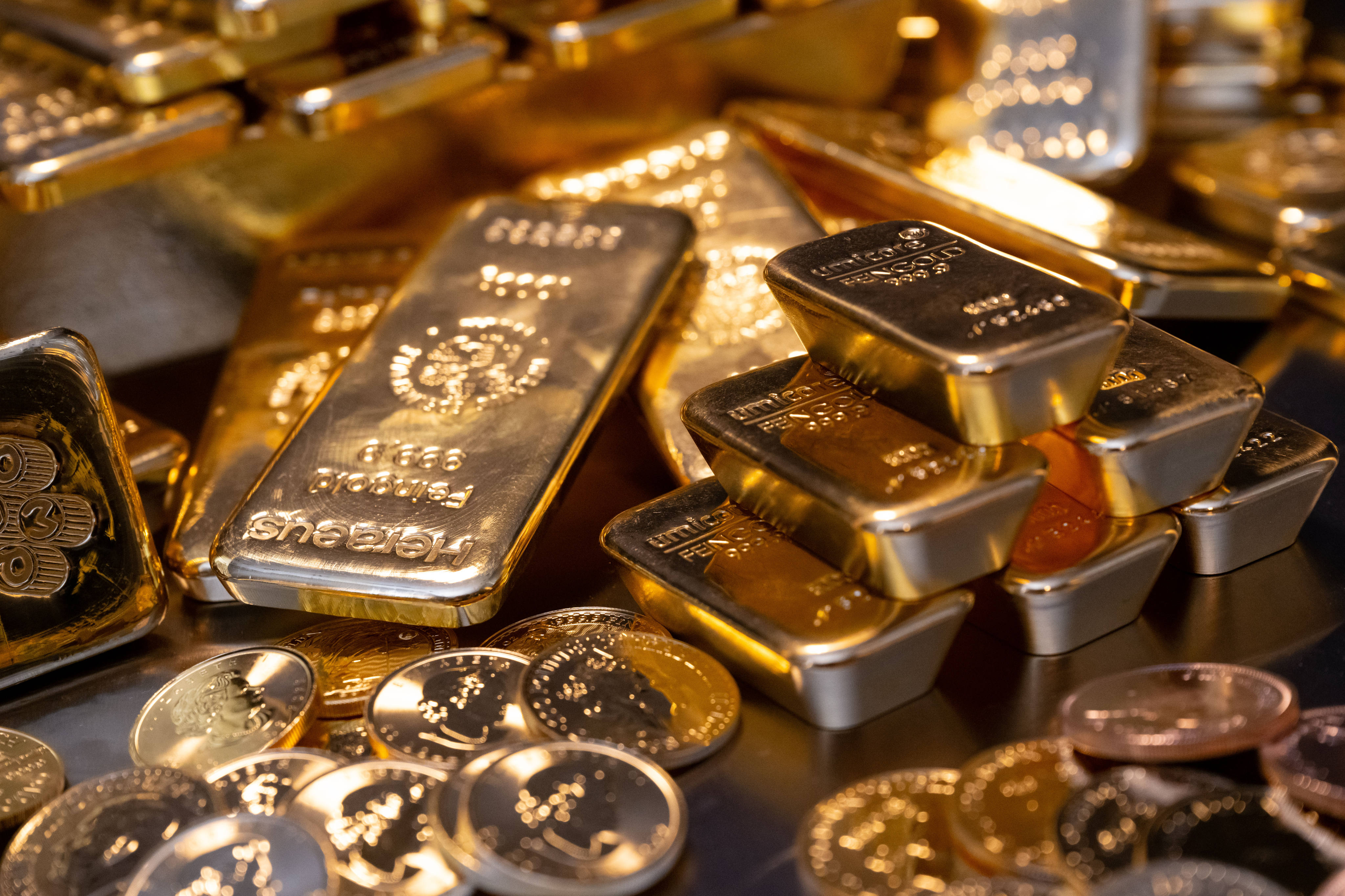 Gold bars and coins lie in a safe at the precious metal dealer Pro Aurum in Munich. Photo: DPA