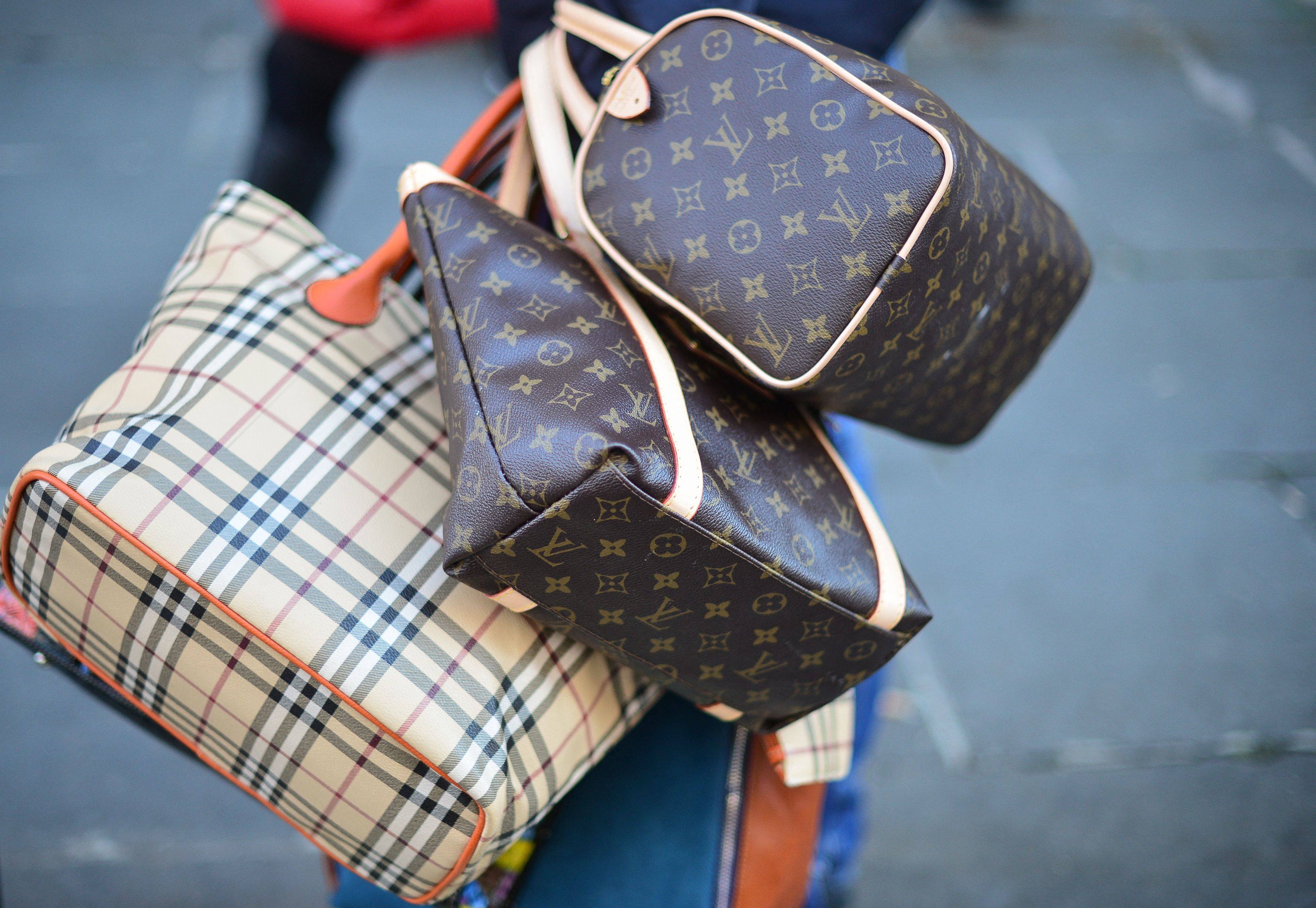A seller carries counterfeit bags in a street in Rome. Italy’s estimated US$6.5 billion-US$7.5 billion market in counterfeit luxury goods, centred on Naples, generates money for the mafia. Photo: AFP