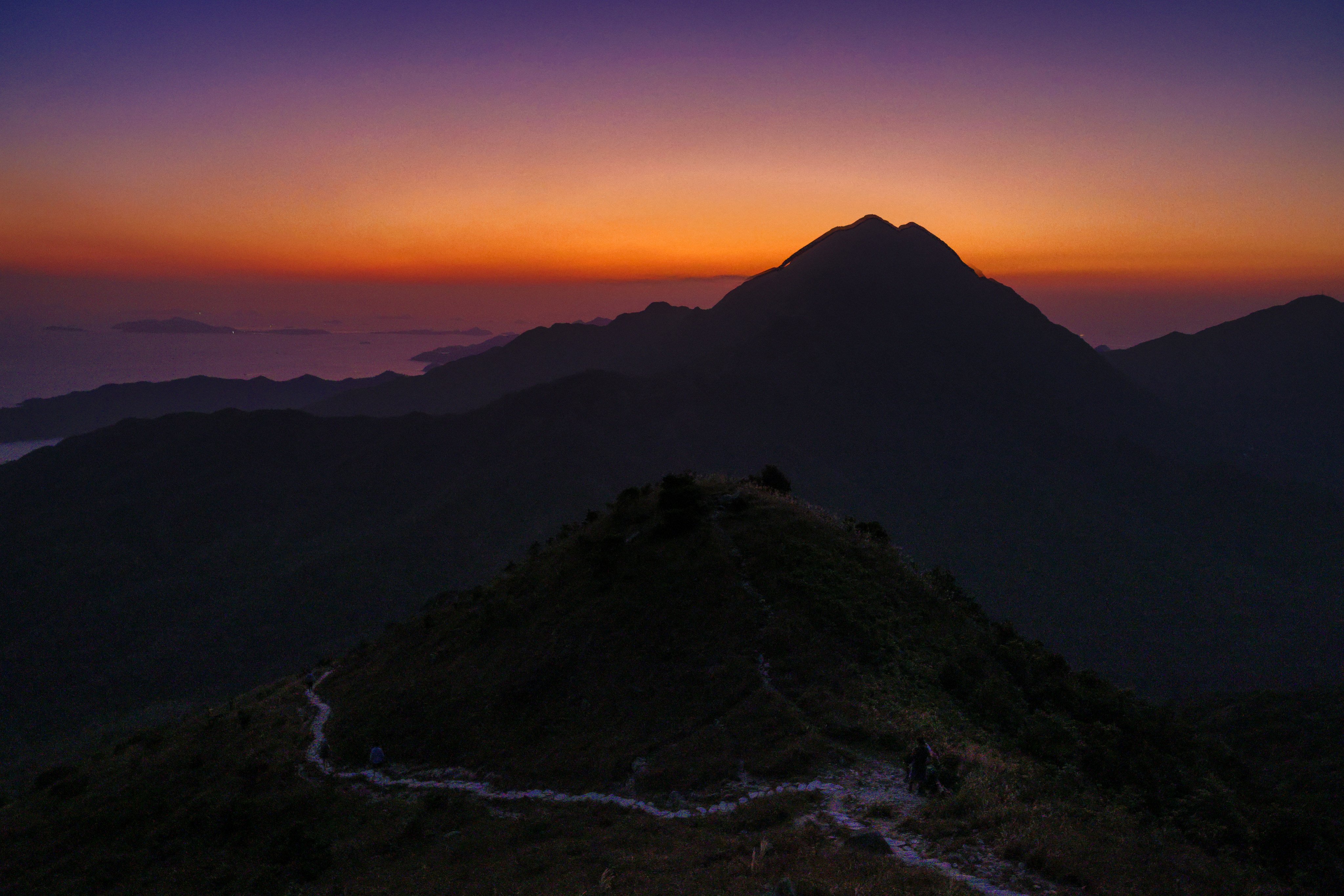 The waters around Lantau Island shimmer in the sunset as seen from Hong Kong’s third highest mountain on November 1, 2023. The government’s plan to reclaim land in the waters off Lantau have sparked much debate. Photo: Dickson Lee