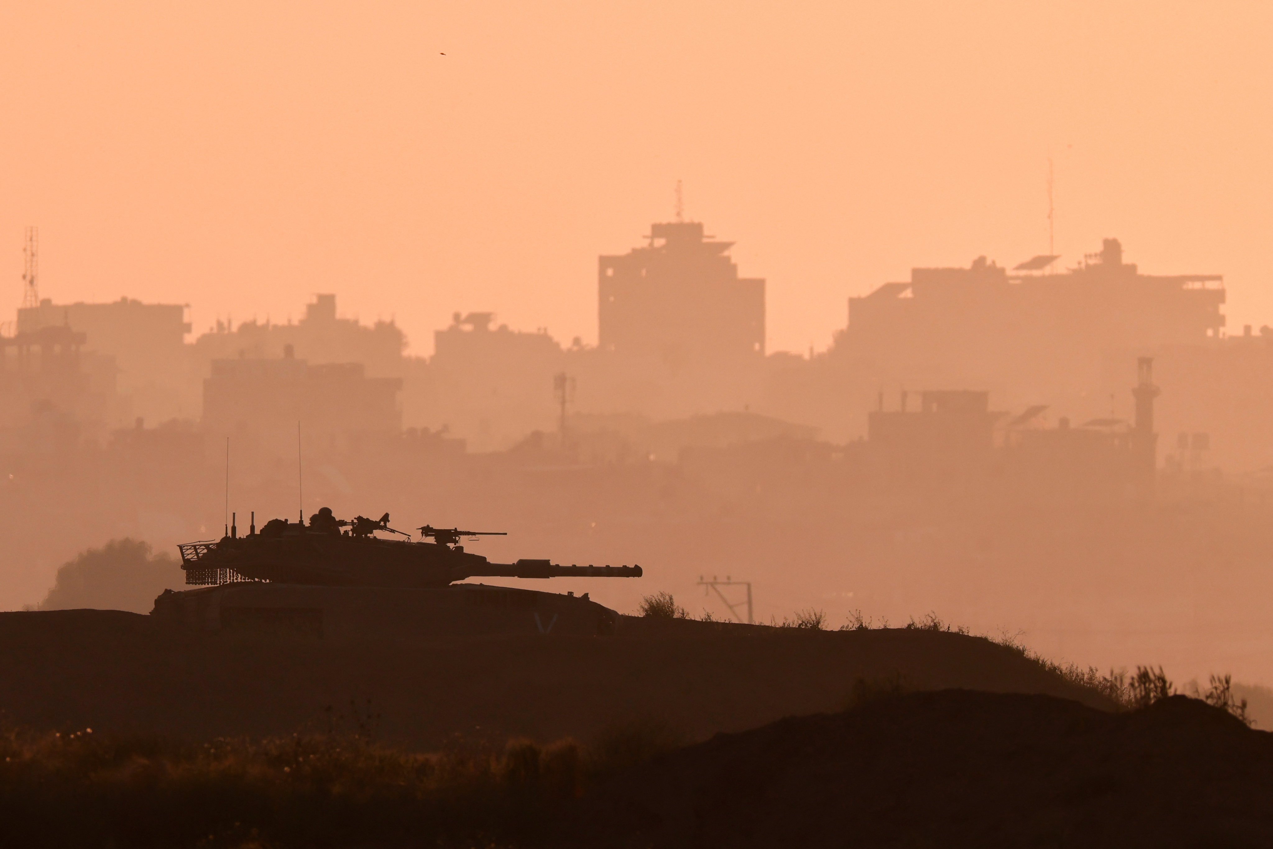 Israeli soldiers patrol in a tank near the Israel-Gaza border. Photo: Reuters