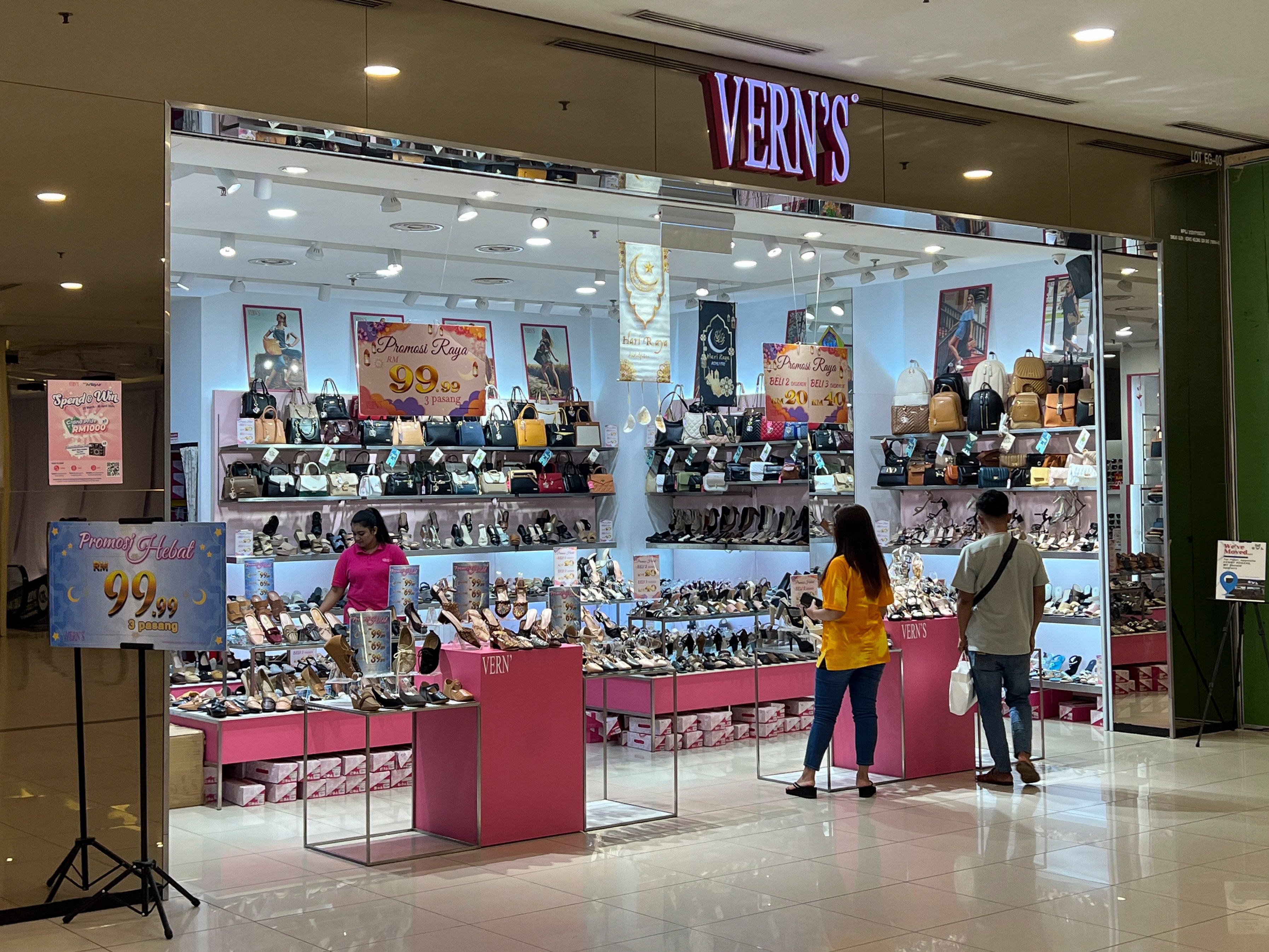 People shop at a Vern’s outlet at a shopping centre in Kuala Lumpur. Vern’s Holdings said the logo stamped on the soles of some high-heeled shoes depicted the silhouette of a stiletto heel with an ankle spiral wrap, not Arabic writing. Photo: AP