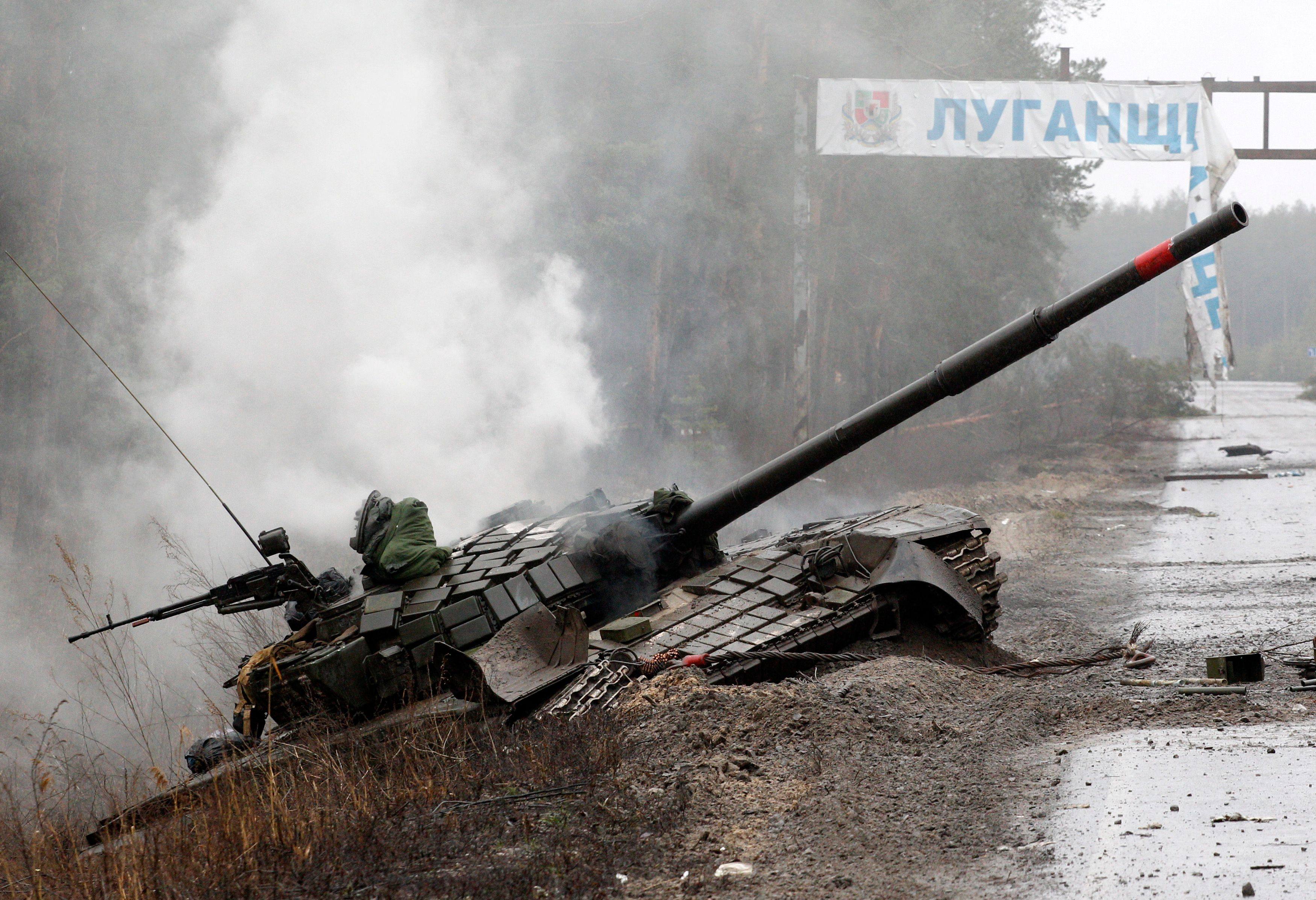 Smoke rises from a Russian tank destroyed by Ukrainian forces. According to UK intelligence, Russia is losing close to a 1,000 troops a day on the Ukraine battlefield. Photo: AFP