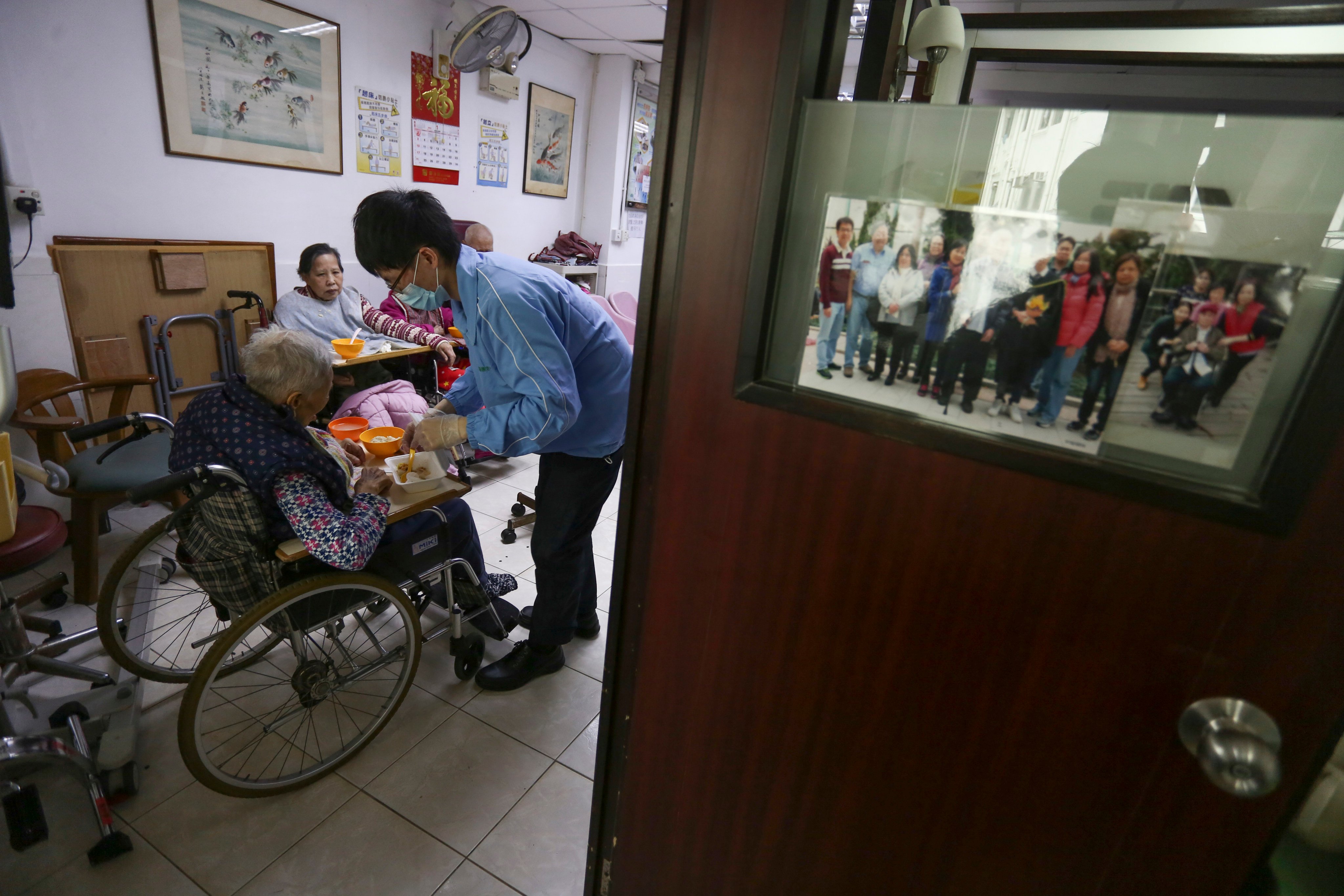 A healthcare worker attends to an elderly resident at a nursing home in Sham Shui Po. Photo: Jonathan Wong