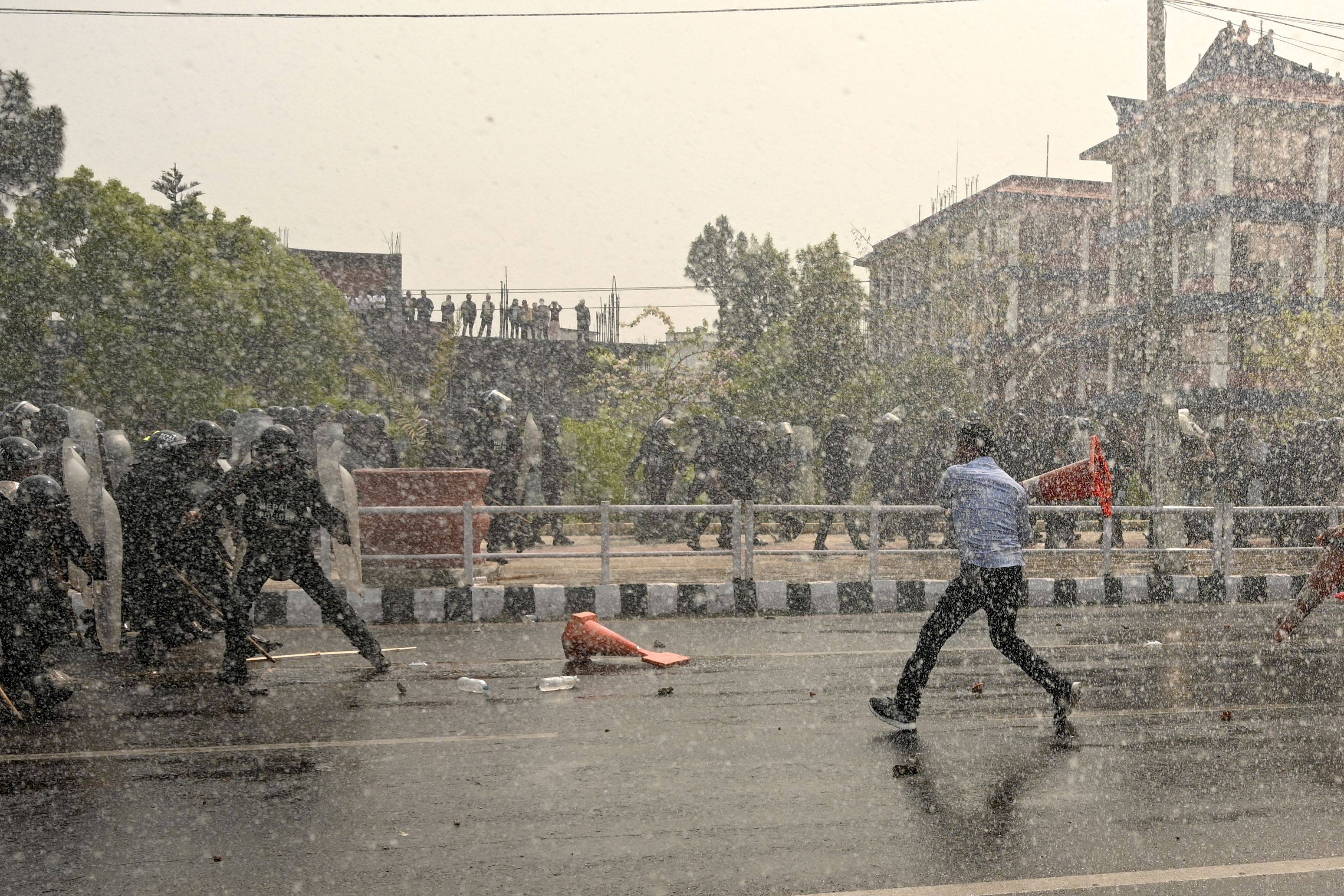 Security personnel use water cannon to disperse demonstrators during a protest to demand the restoration of monarchy and the status of a Hindu state in the nation. Photo: AFP