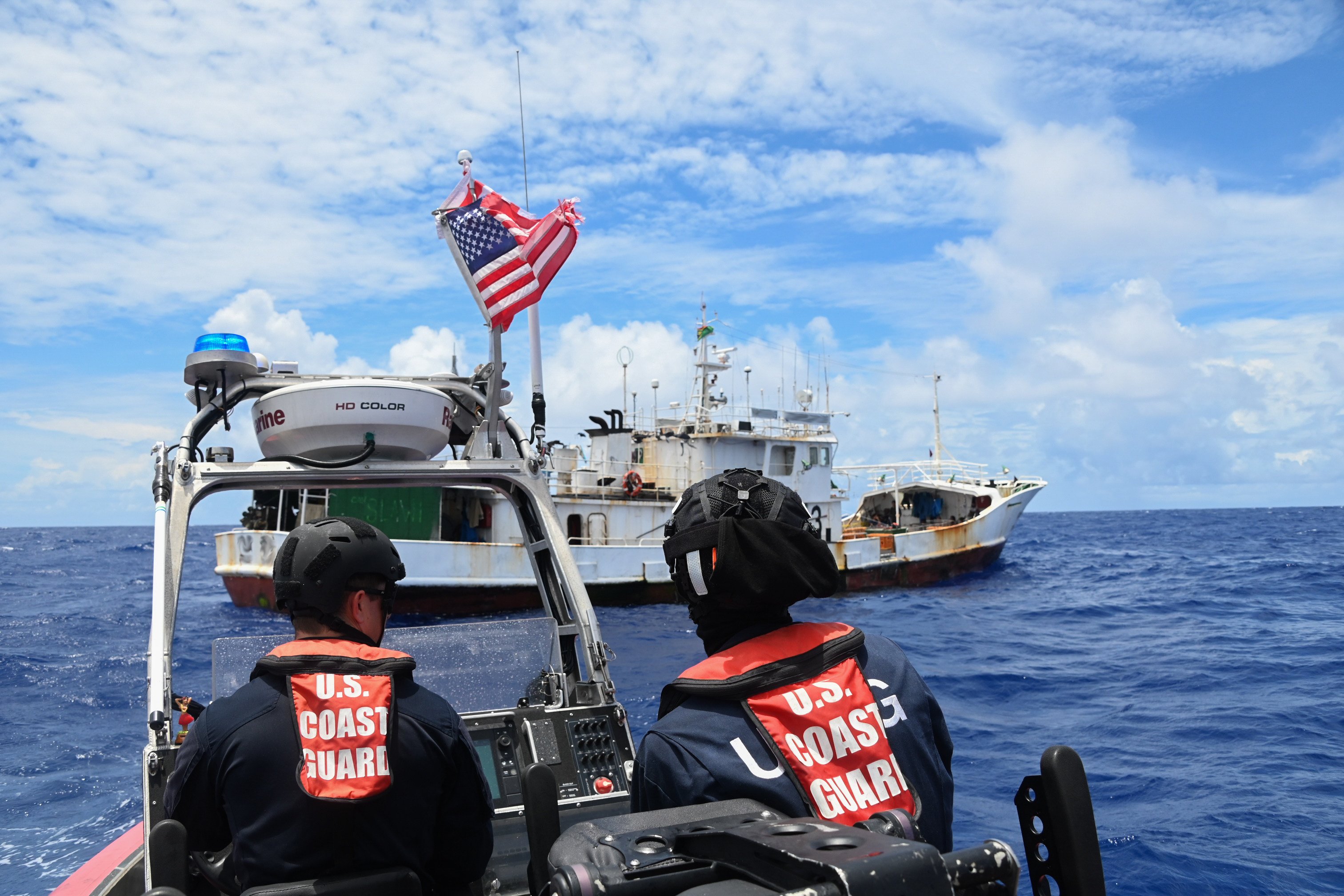 A US Coast Guard small boat crew waits for Vanuatu fishery department and police officials to conduct a boarding in the Pacific nation’s exclusive economic zone in February. Photo: US Coast Guard Pacific Area