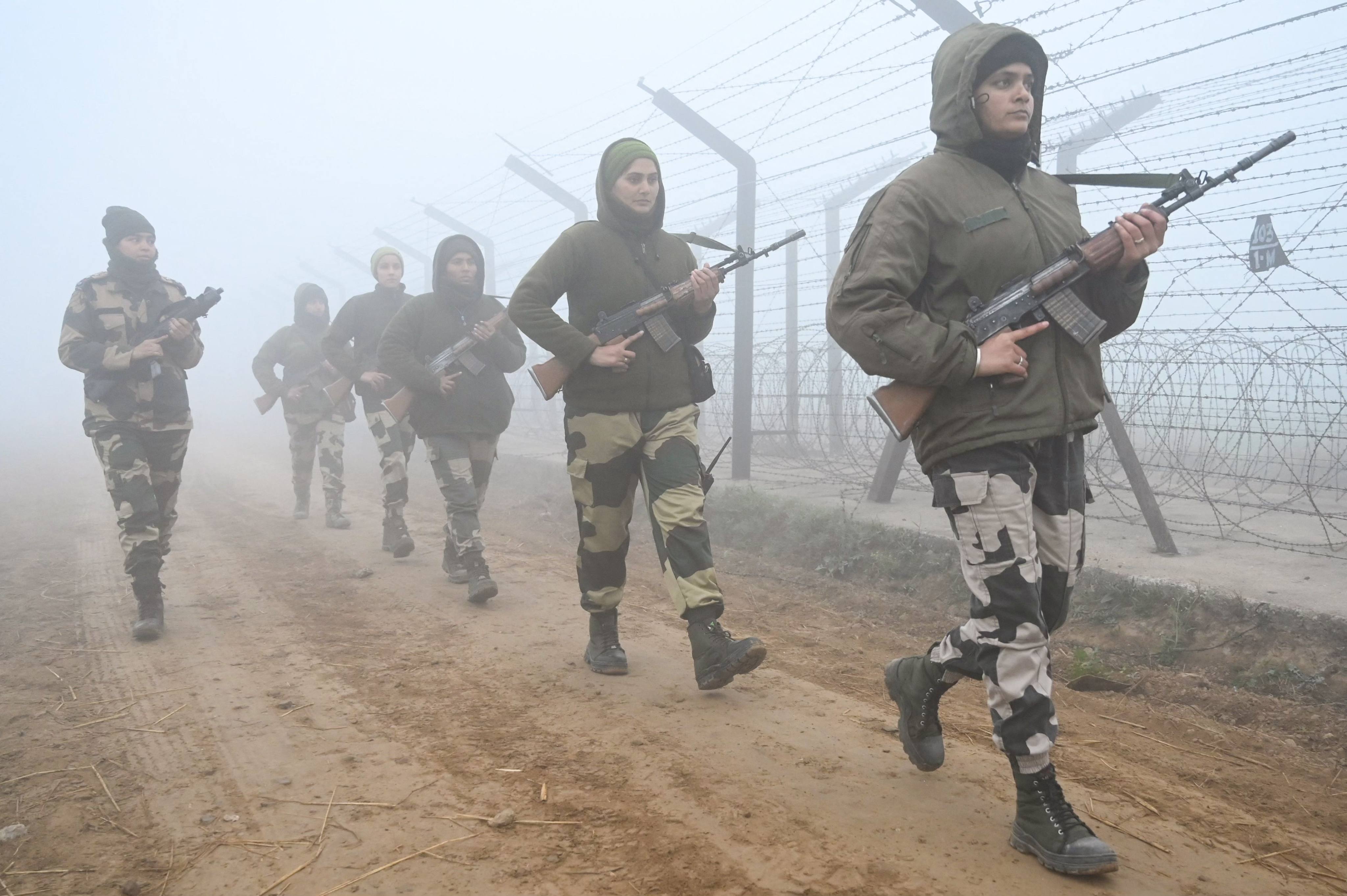 Border Security Force personnel patrol along the border fence during a cold, foggy morning near India-Pakistan Wagah border about 40km from Amritsar in December 2022. Photo: AFP