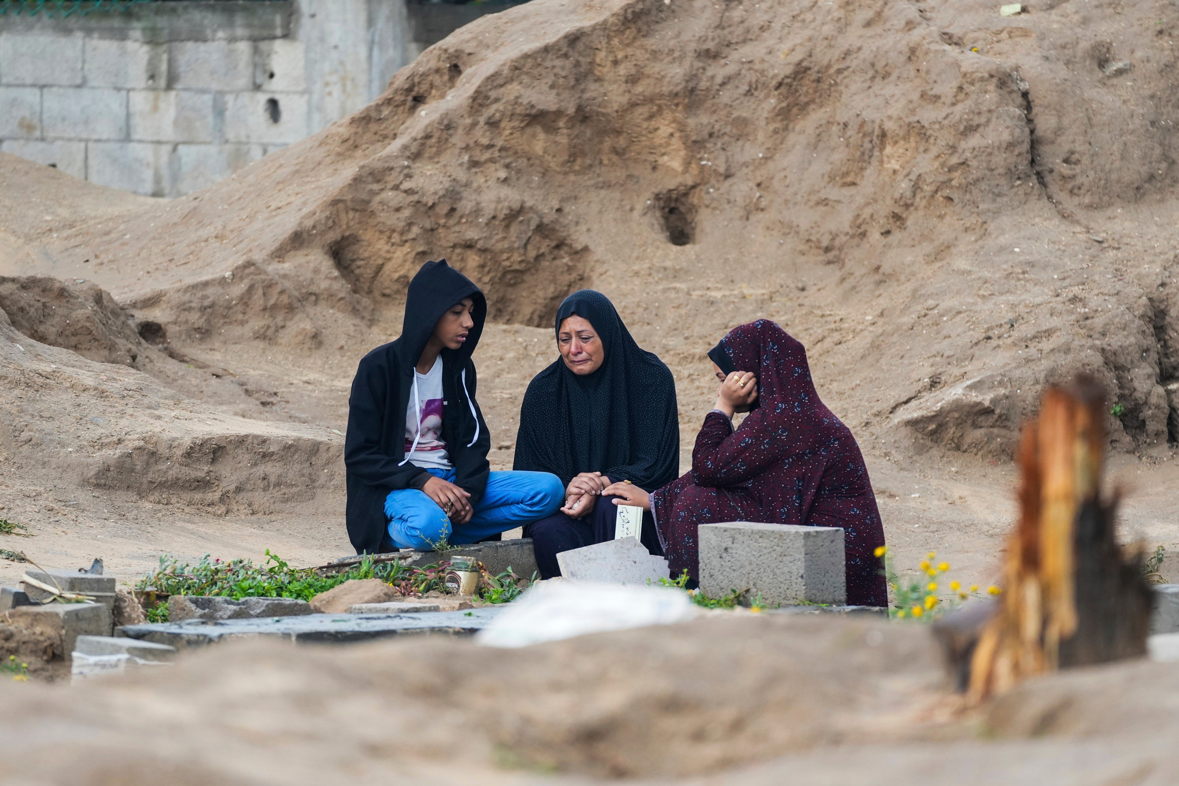 Palestinians visit the graves of their relatives who were killed in the war between Israel and the Hamas militant group on the first day of the Muslim holiday of Eid al-Fitr, in Deir al-Balah, Gaza on Wednesday. Photo: AP