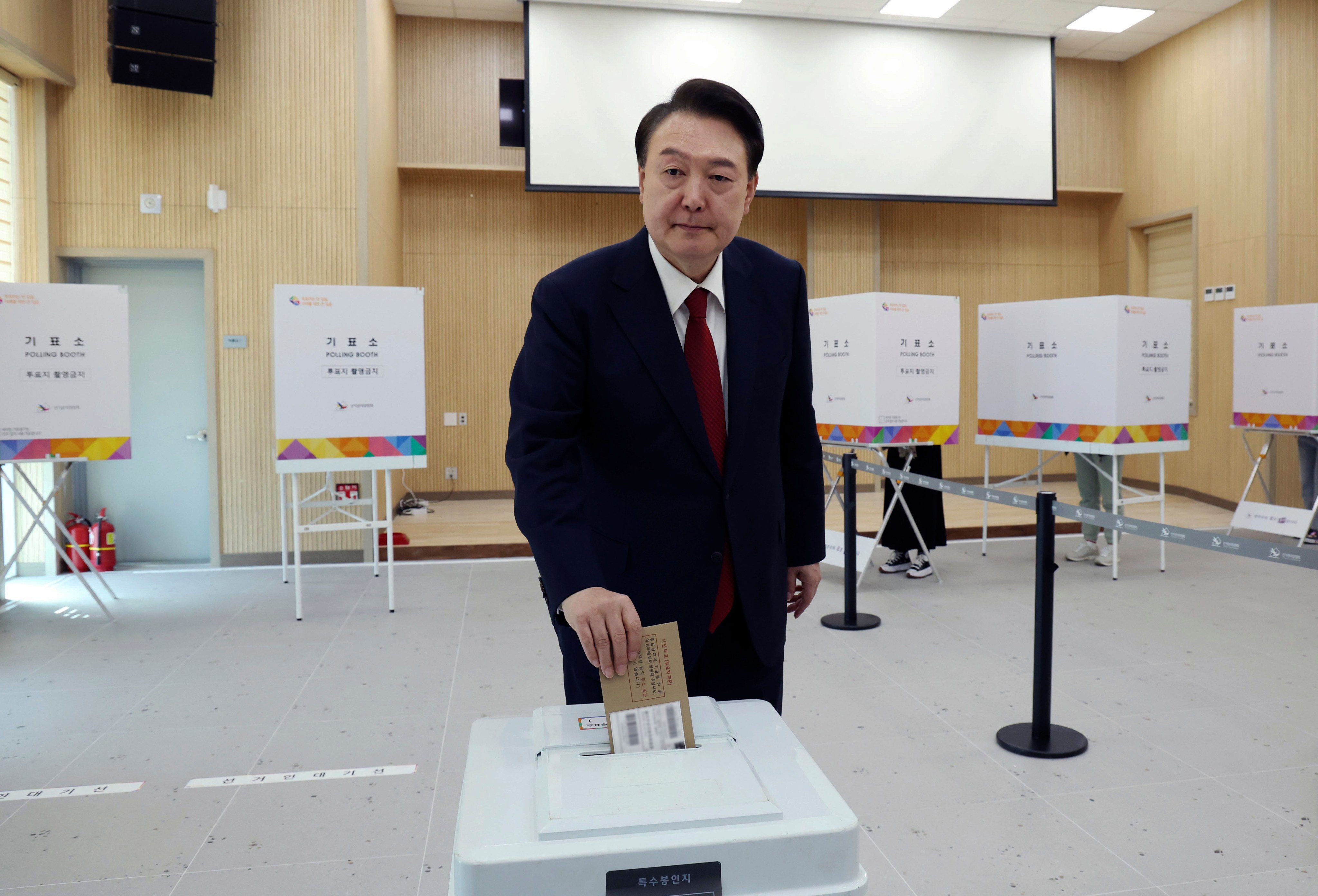 South Korean President Yoon Suk-yeol casts his vote at a polling station in Busan. Yoon’s ruling People Power Party suffered a crushing a defeat in the April 10 general election. Photo: Yonhap via AP
