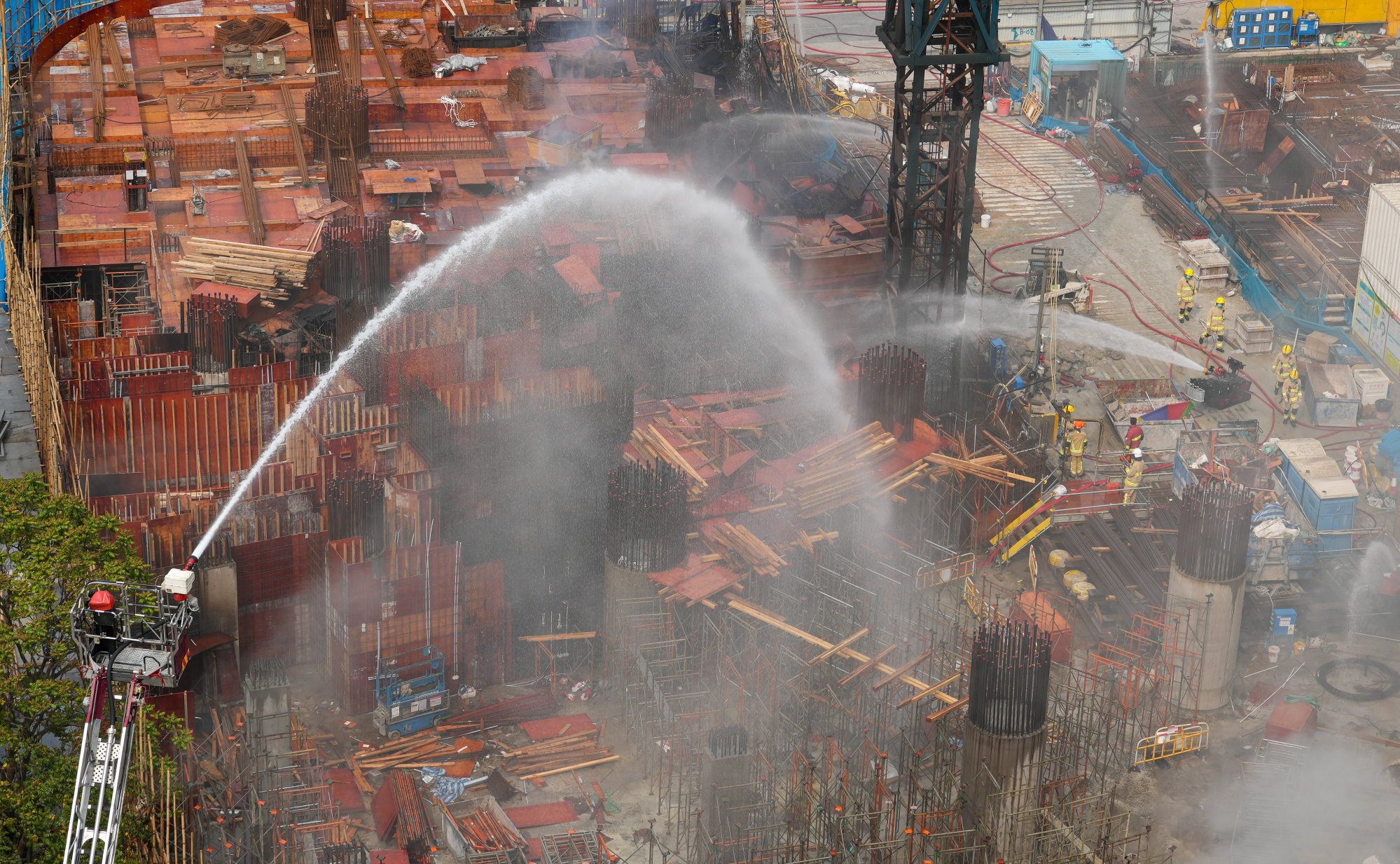 Firefighters battle the blaze at the construction site. Authorities said explosions occurred in the basement, possibly linked to oxyacetylene cylinders. Photo: May Tse
