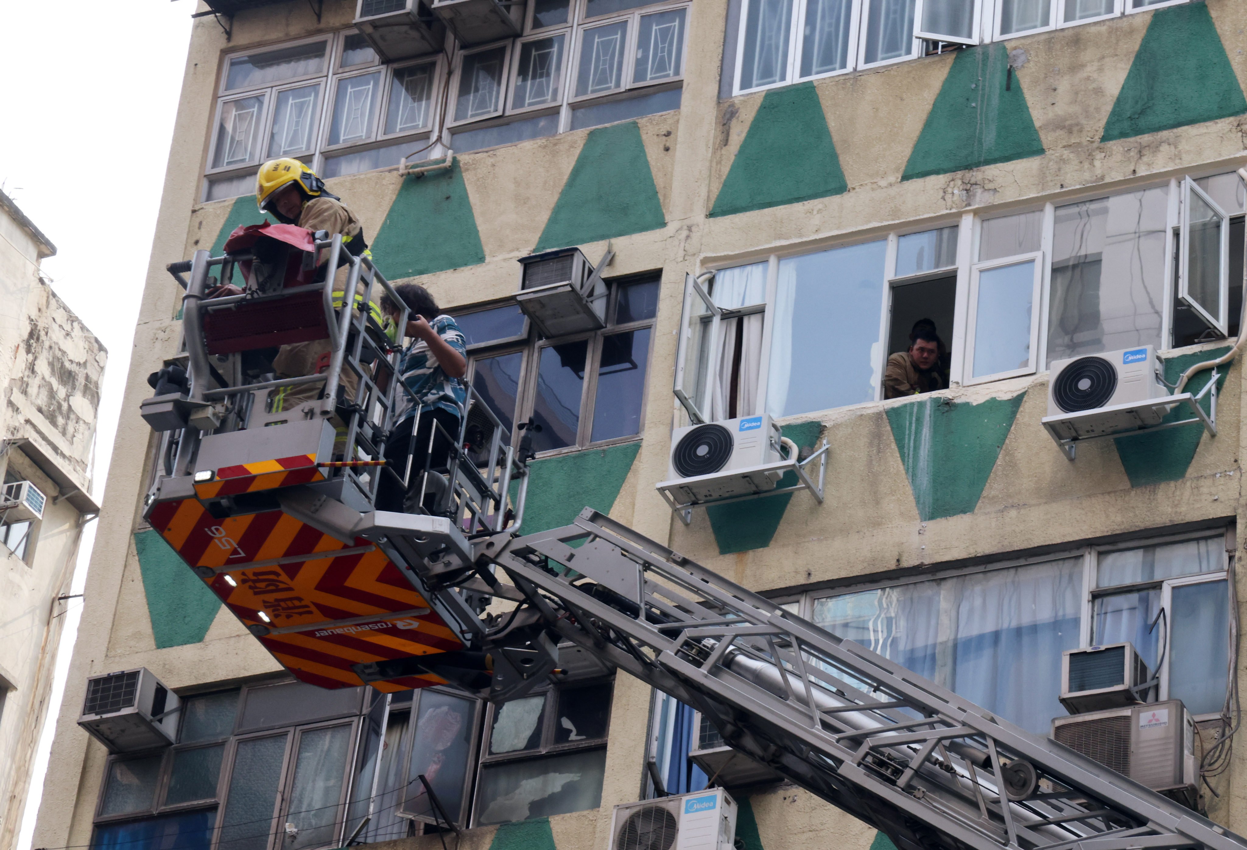 Firefighters rescue residents of New Lucky House on Wednesday. Five people died in the blaze. Photo: Jelly Tse