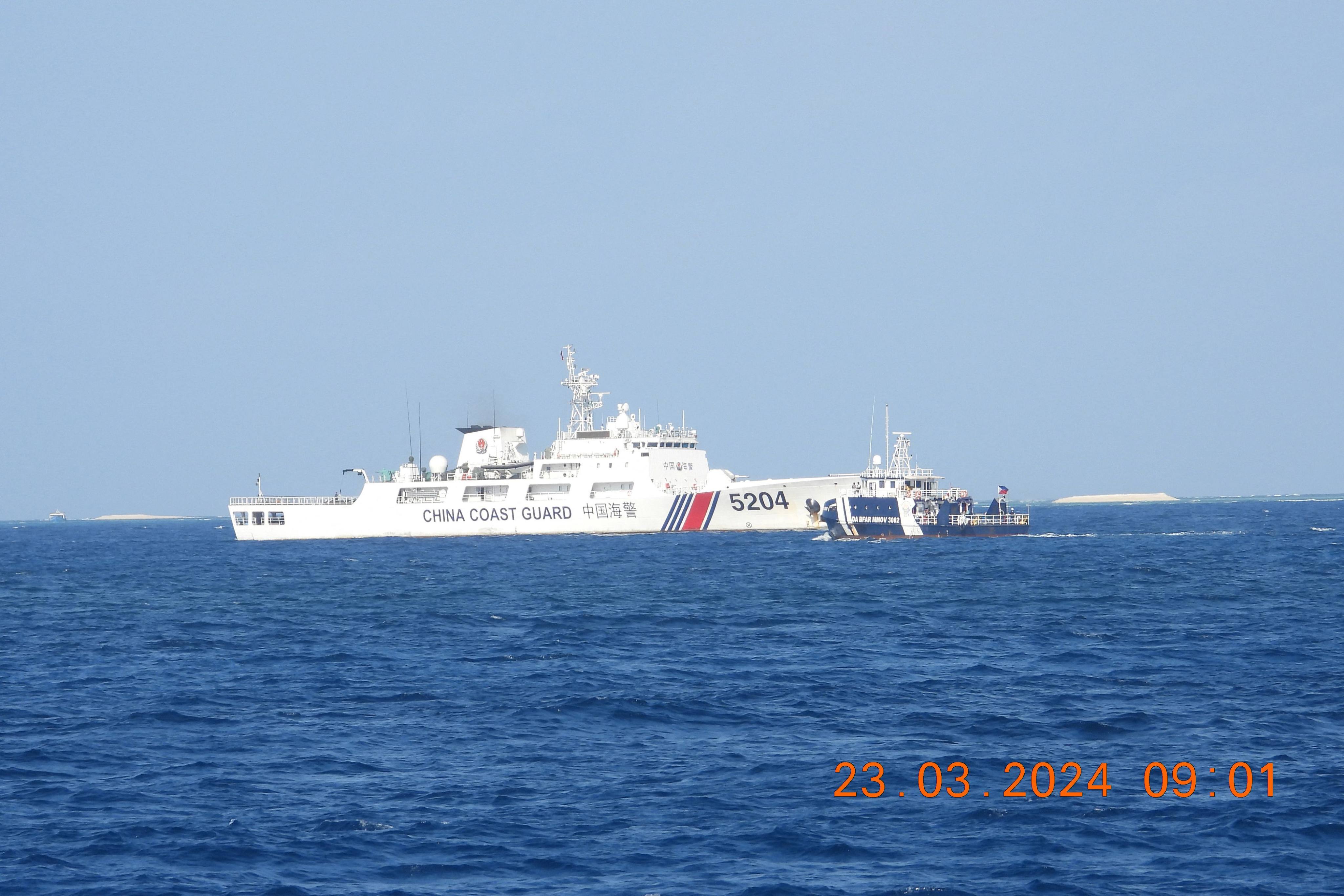 A China Coast Guard ship (left) blocks a Philippine vessel (right) near the Manila-held Thitu Island in the disputed South China Sea on March 23, 2024. Photo: AFP
