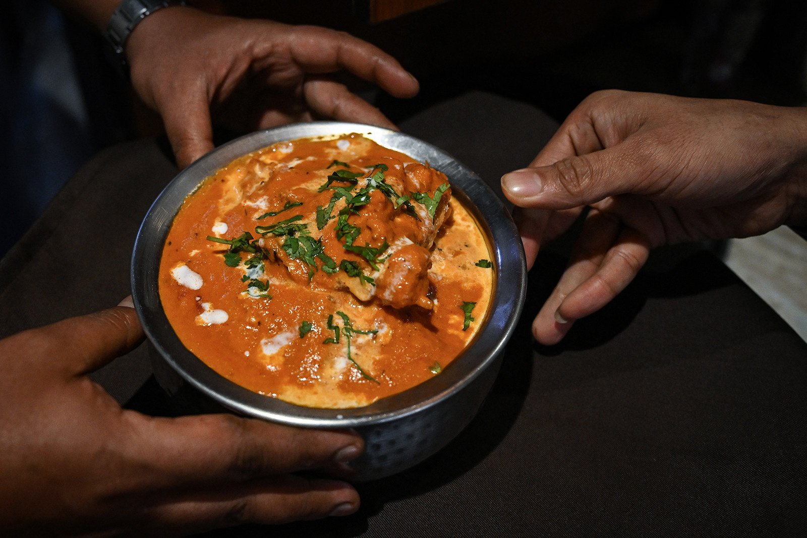 A waiter serves butter chicken at the Moti Mahal restaurant in New Delhi. Photo: TNS
