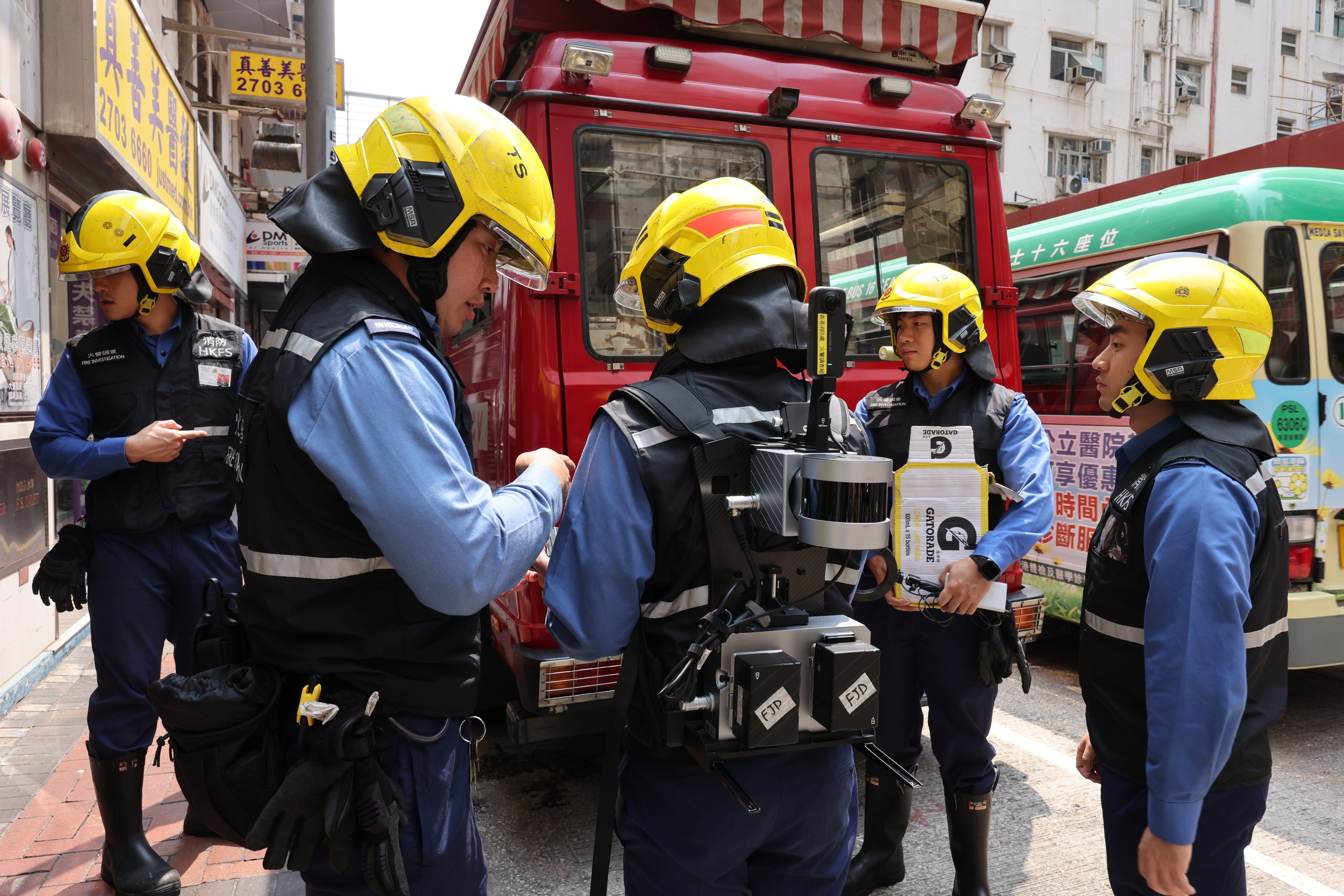 Fire Services Department personnel prepare to enter a blaze-hit building Yau Ma Tei. Photo: Jelly Tse