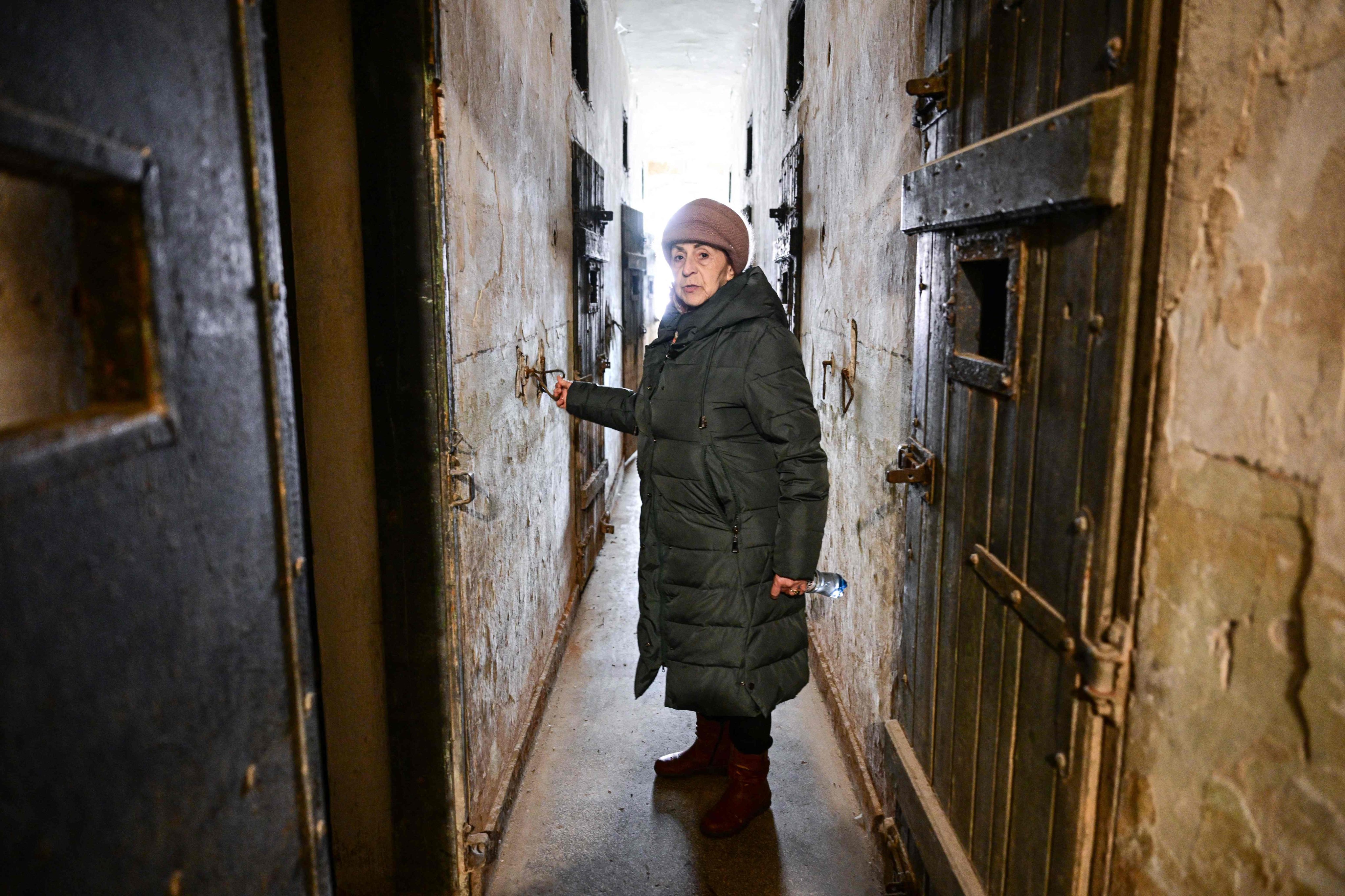 Niculina Moica, 80, detained as a teenager at Jilava prison by Romania’s then Communist regime, shows the isolation cells at Jilava prison, which she is campaigning to have preserved as a monument. Photo: AFP