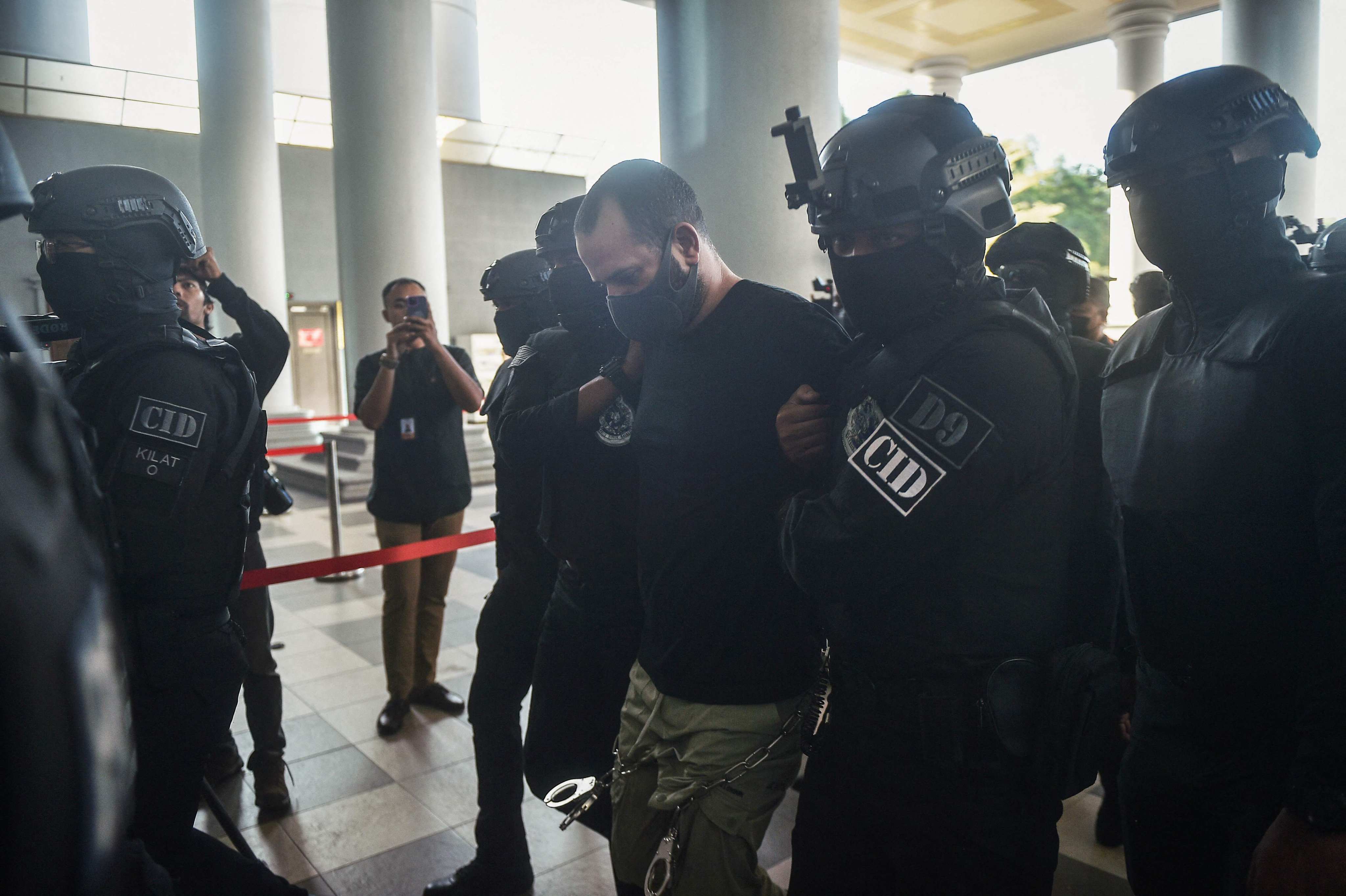 Israeli national Shalom Avitan (centre) is escorted by Malaysian police upon his arrival at a court in Kuala Lumpur on Friday. Photo: AFP