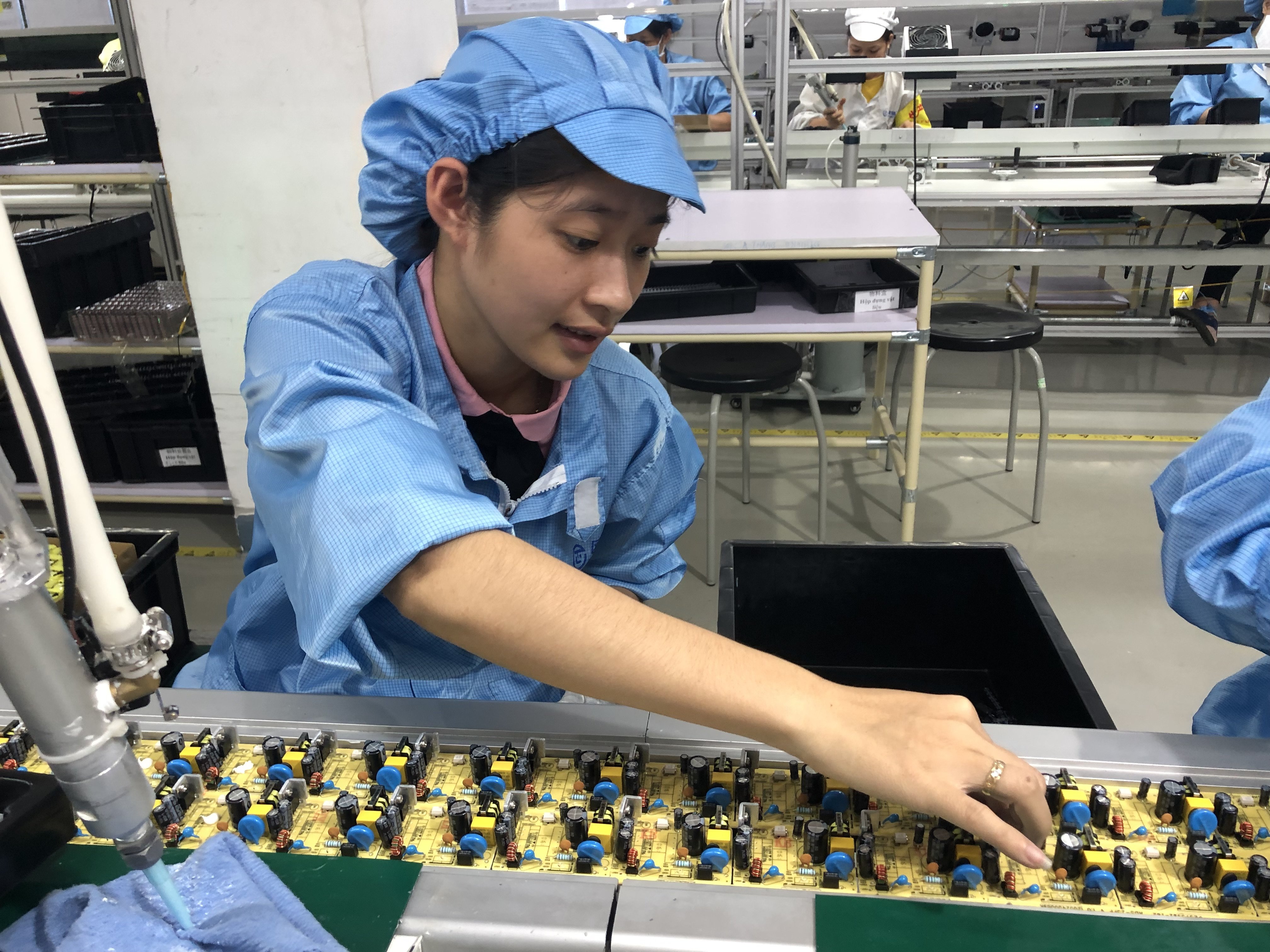 A worker helps make adapters on a production line in a plant in the Vietnam-China Economic and Trade Cooperation Park in 2019. Photo: Cissy Zhou