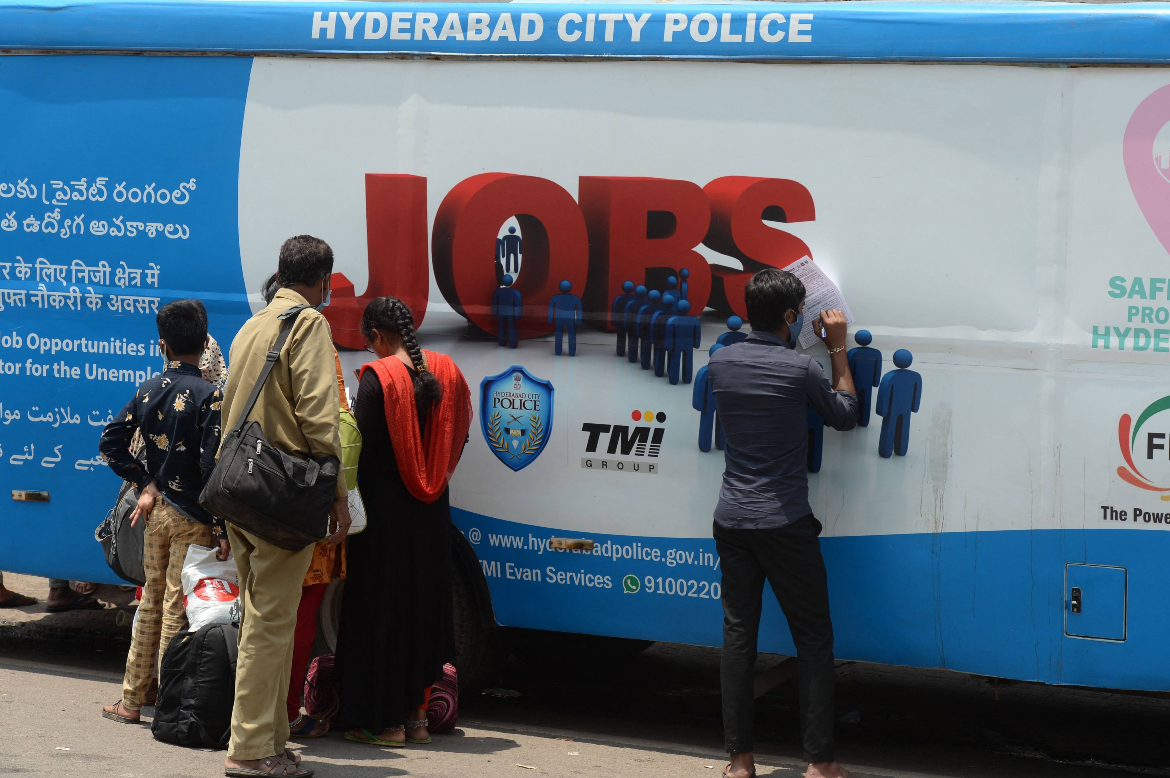 Unemployed youths fill application forms to access job openings in the private sector in Hyderabad, India. Photo: AFP