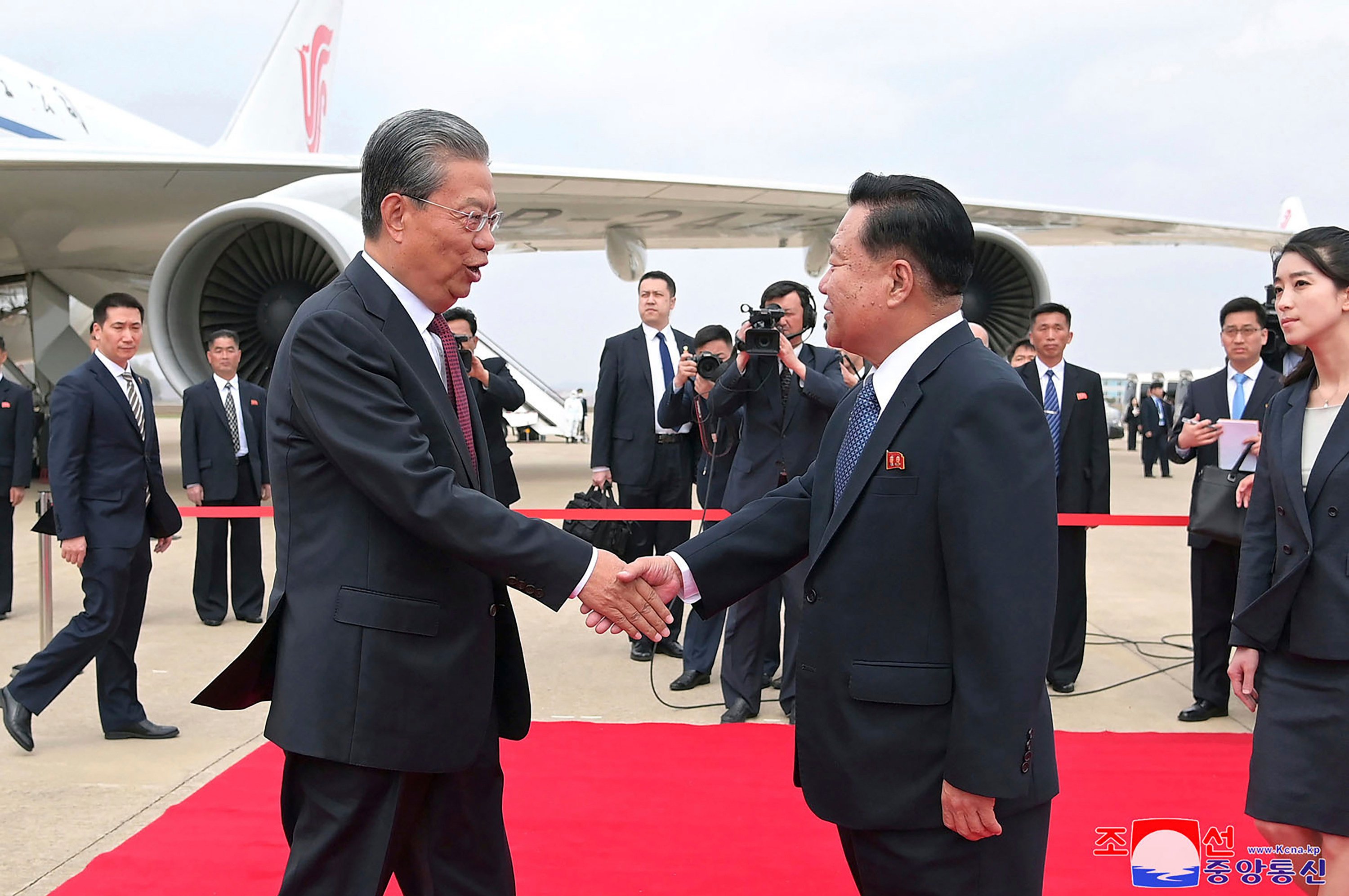 Choe Ryong-hae, vice-chairman of the central committee of the Workers’ Party of North Korea, receives  NPC chairman Zhao Leji at the Pyongyang International Airport on Thursday. Photo: KCNA via AP 