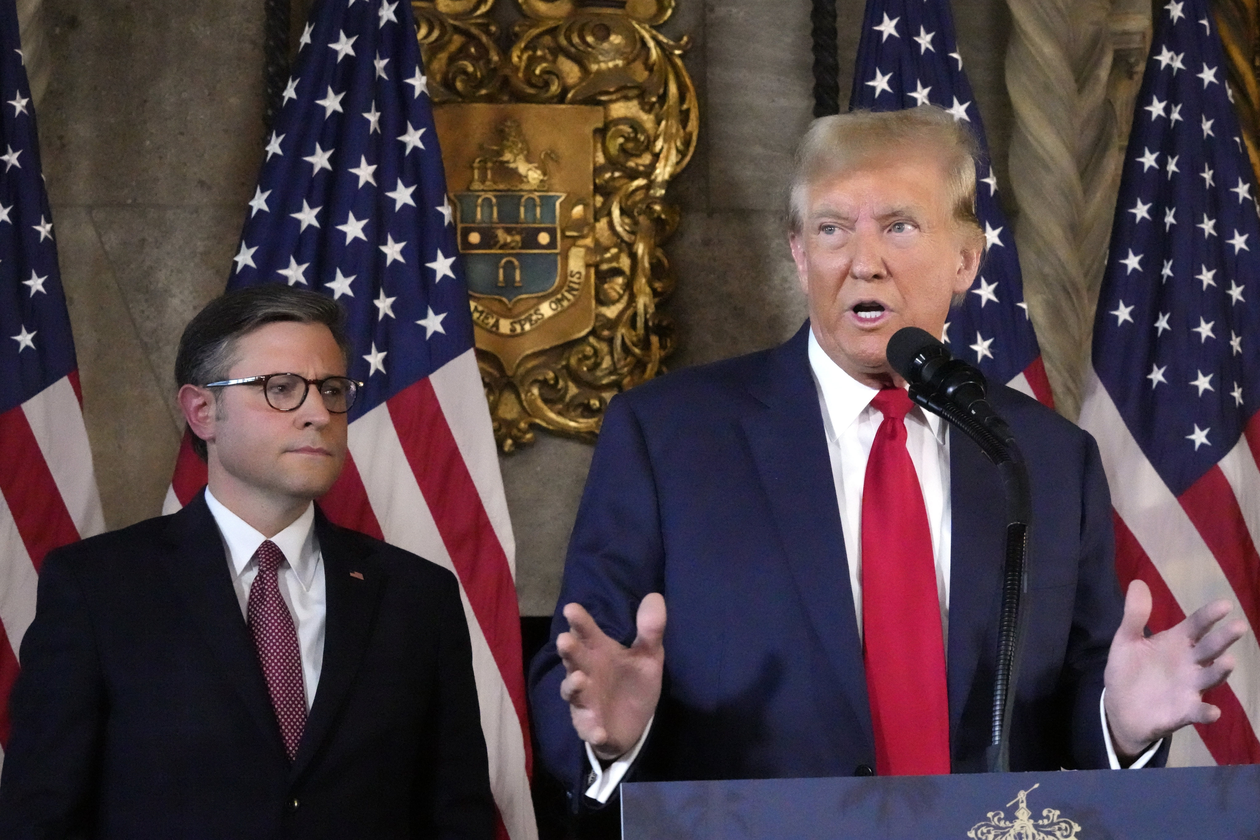 Republican presidential candidate former Donald Trump speaks as House Speaker Mike Johnson listens during a news conference at Mar-a-Lago on Friday. Photo: AP