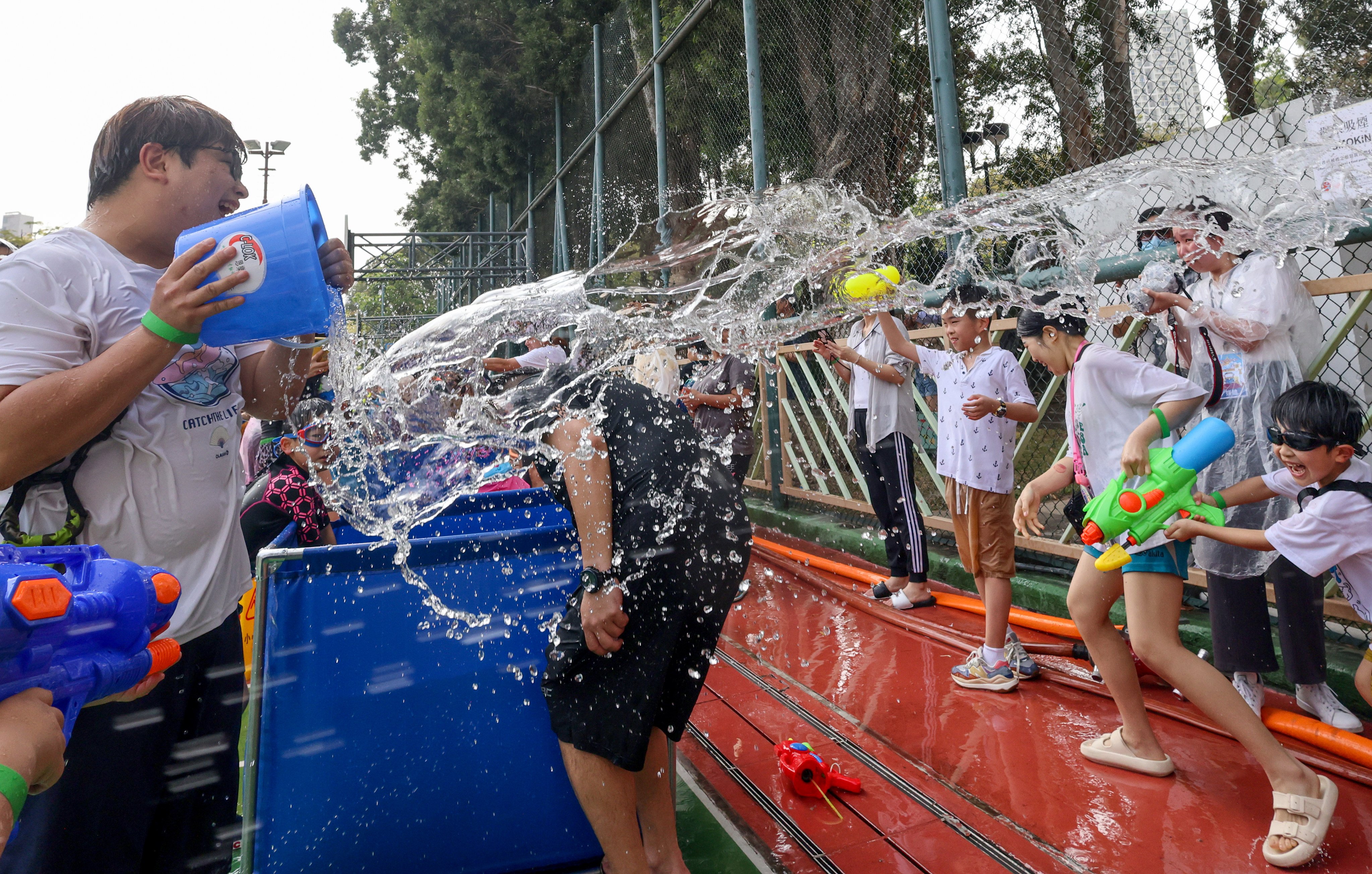 Songkran is celebrated in Kowloon City on Saturday. Participants splashed and sprayed water as a way to symbolically send luck and happiness. Photo: Dickson Lee