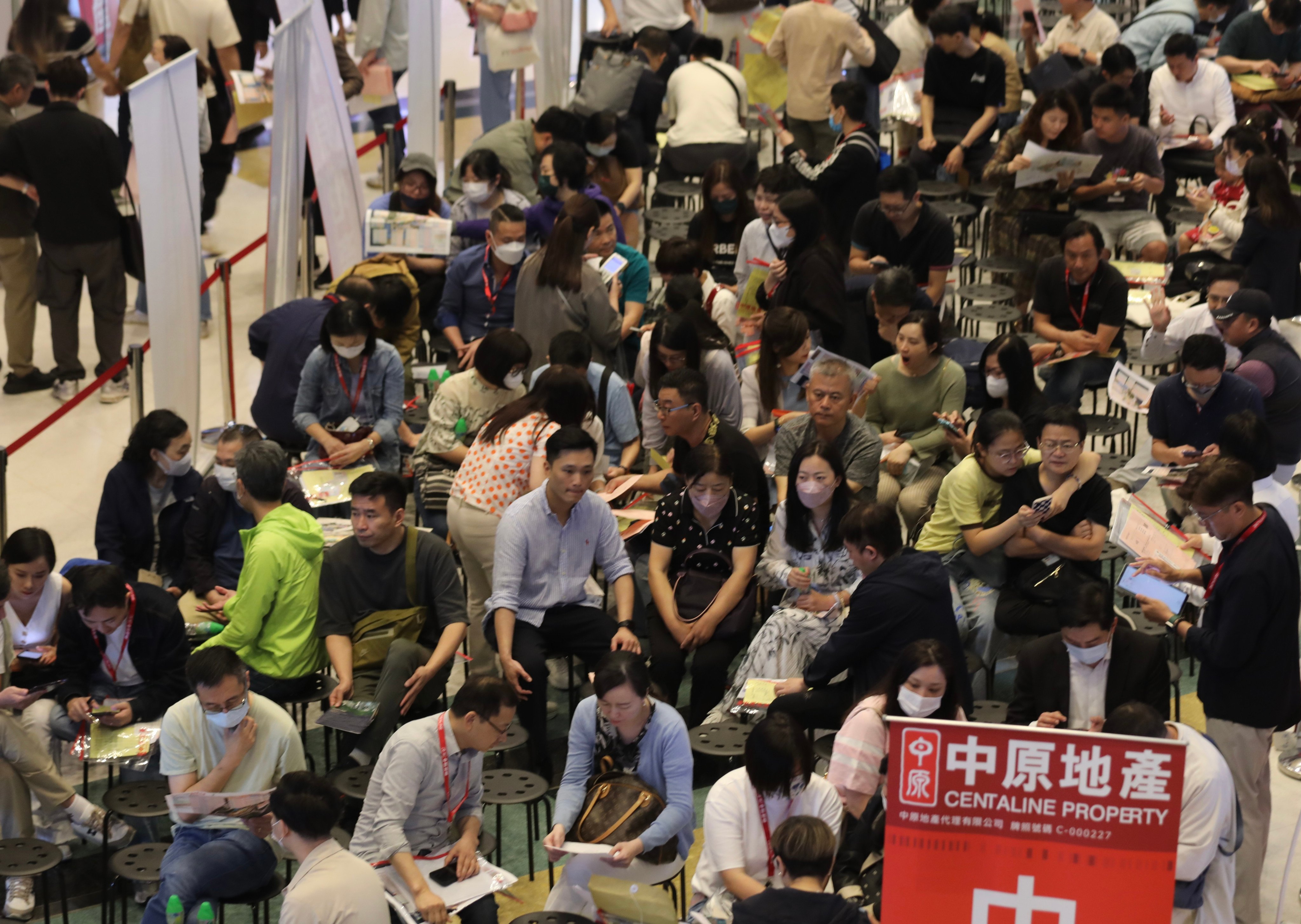 Prospective homebuyers gathered at CK Asset’s sales office in in Hung Hom to wait for the results of the Blue Coast lottery. Photo: SCMP/ Xiaomei Chen