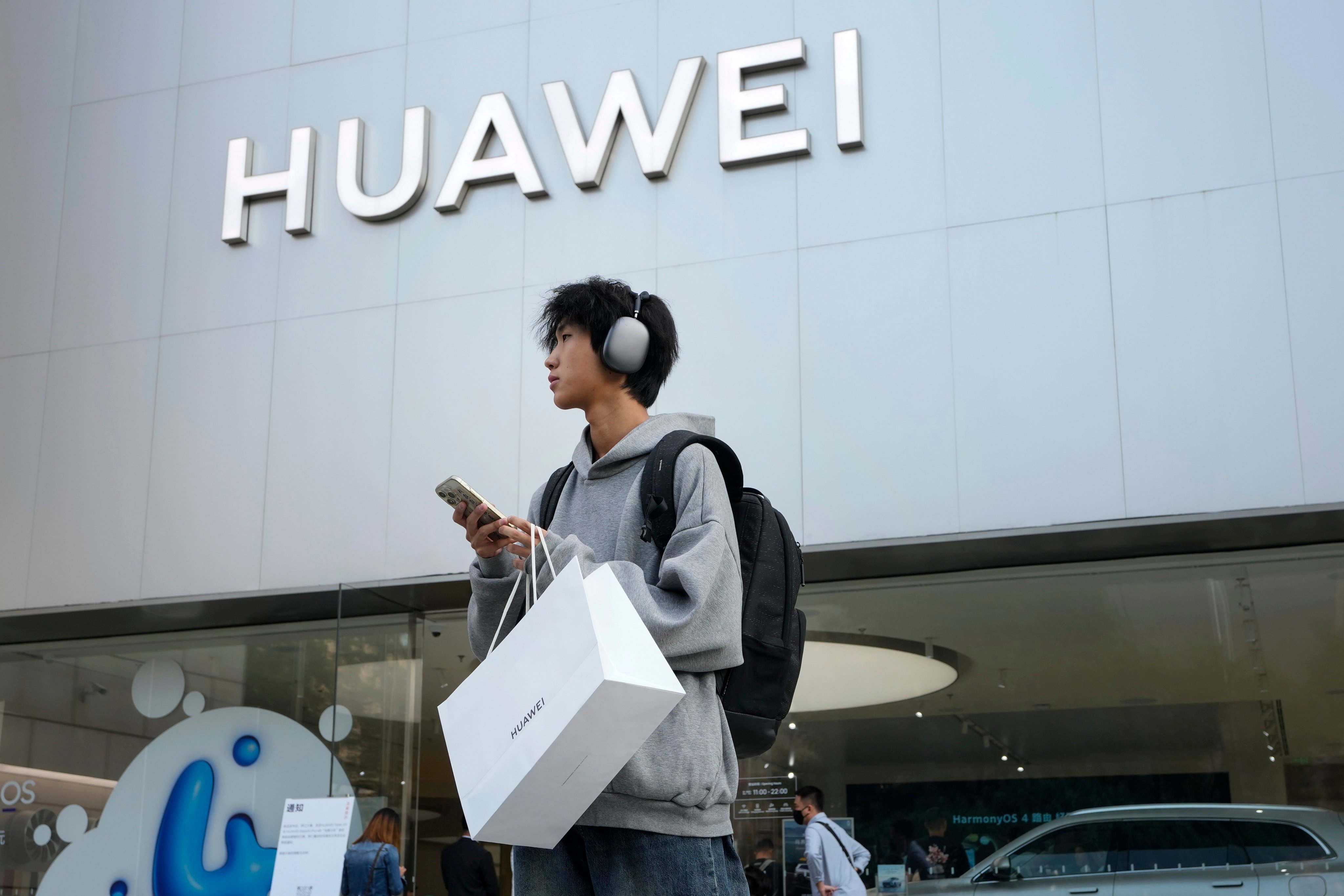 A customer outside a Huawei store in Beijing. Photo: AP