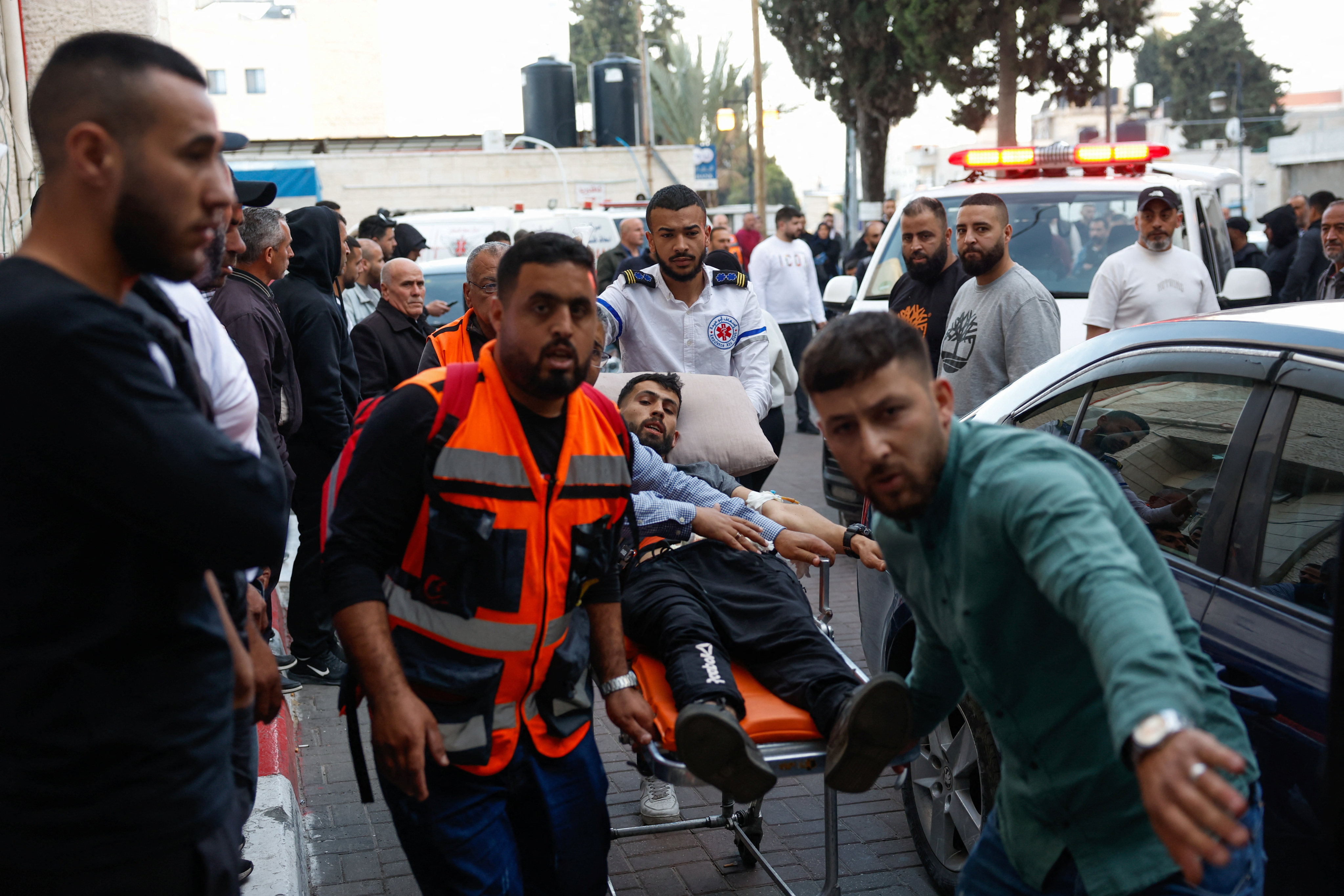 People transport a man wounded in an Israeli settler attack on the village of al-Mughayyir to a hospital in Ramallah, in the Israeli occupied West Bank, on Friday. Photo: Reuters