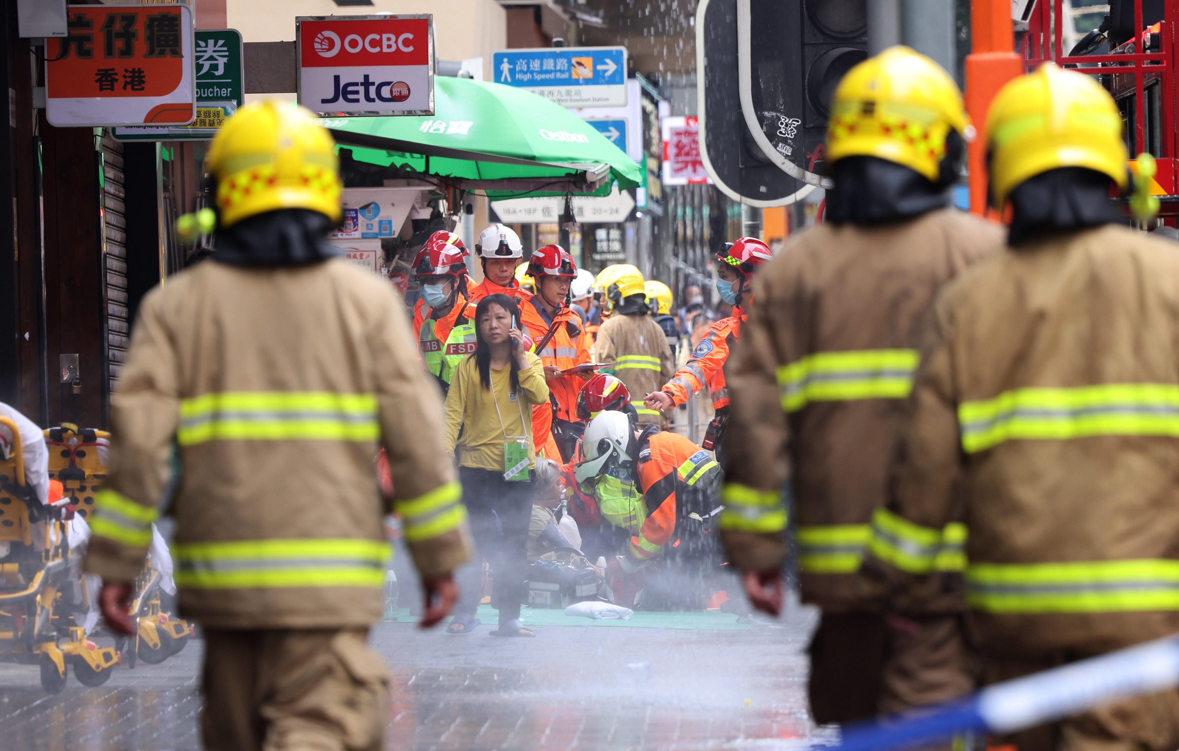 Firefighters and parademics outside New Lucky House at the junction of Jordan Road and Nathan Road on April 10. Photo: Jelly Tse