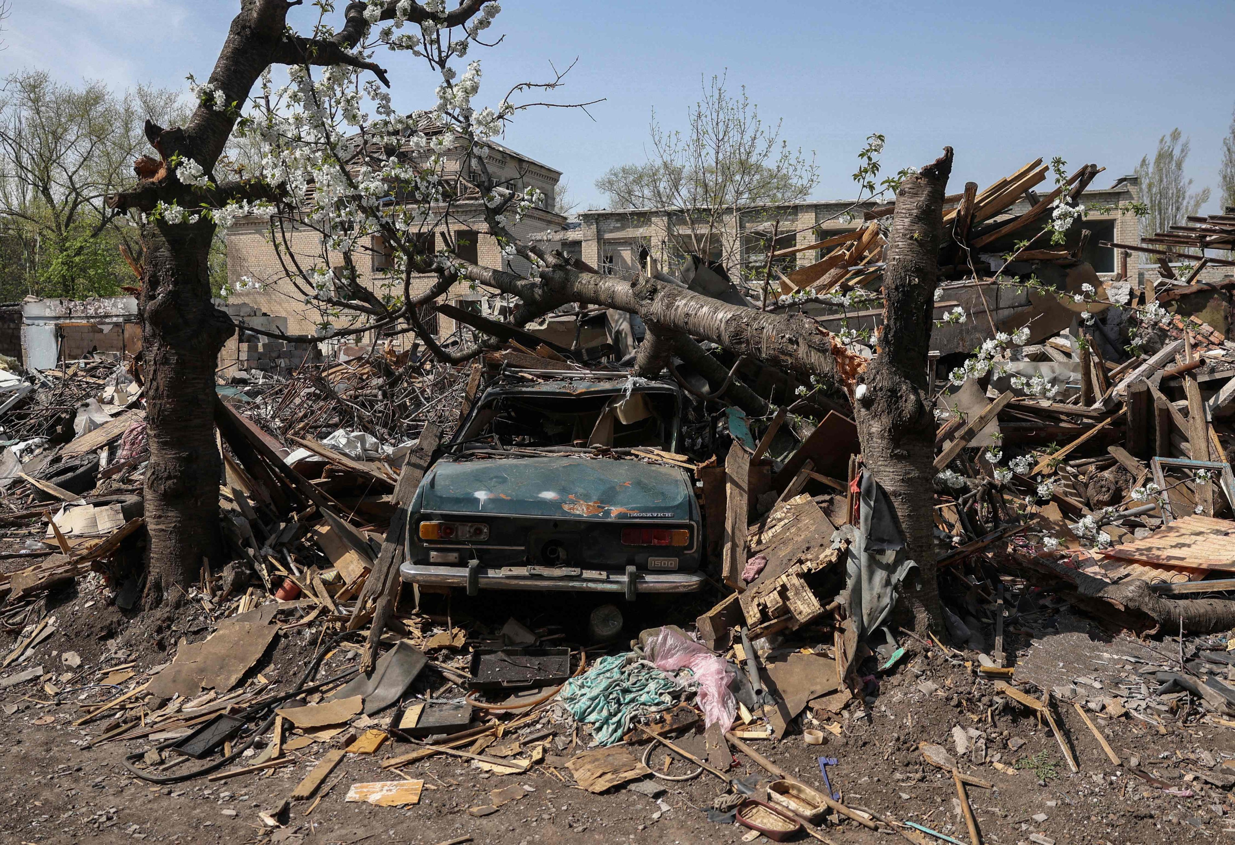A destroyed car is seen in the yard of a house struck by missiles in the town of Selydove, in Ukraine’s Donetsk region, on Friday. Photo: AFP