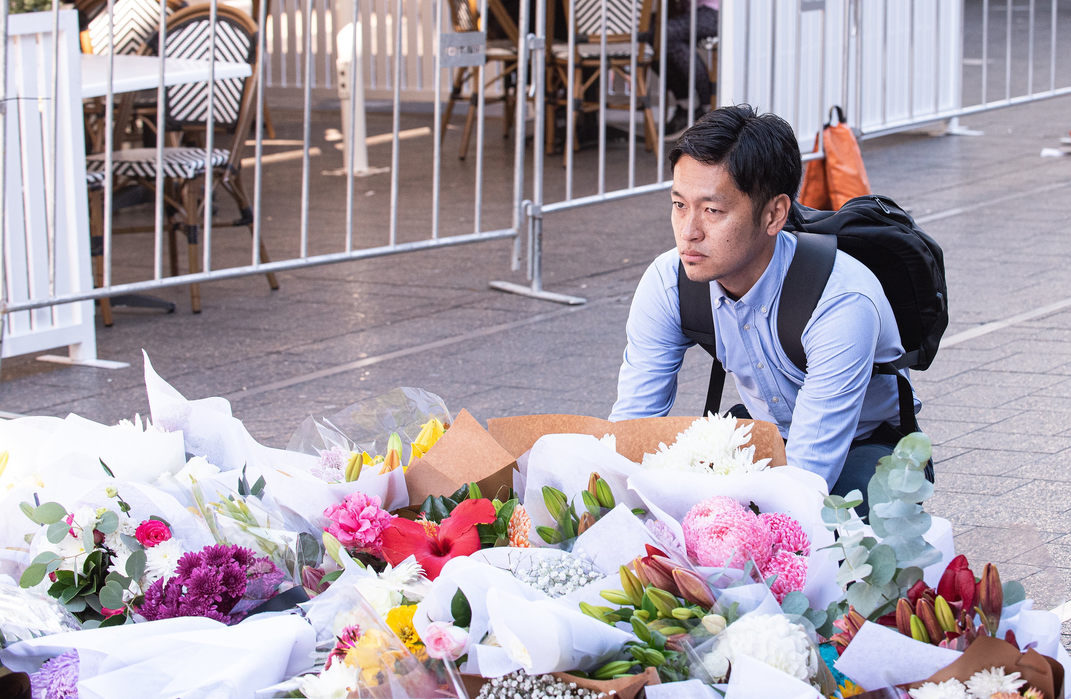 A man reacts near a makeshift memorial outside the Westfield Bondi Junction shopping centre in tribute to the victims of a stabbing spree there on Saturday. Photo: EPA-EFE