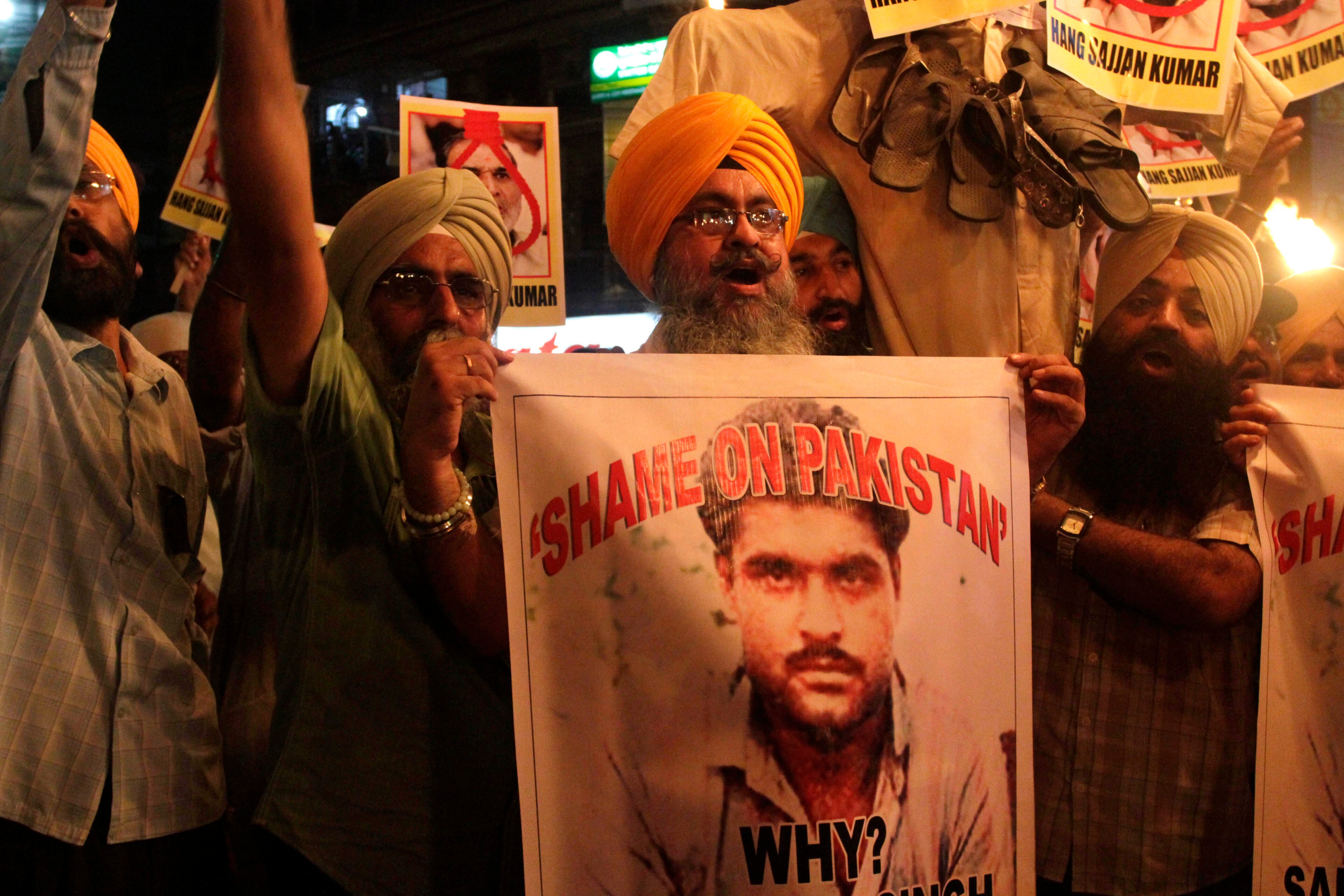 Indian Sikhs in Kolkata, India, protest against Pakistan in 2013 as they hold photographs of Sarabjit Singh, centre, a convicted Indian spy who was on Pakistan’s death row. Photo: AP