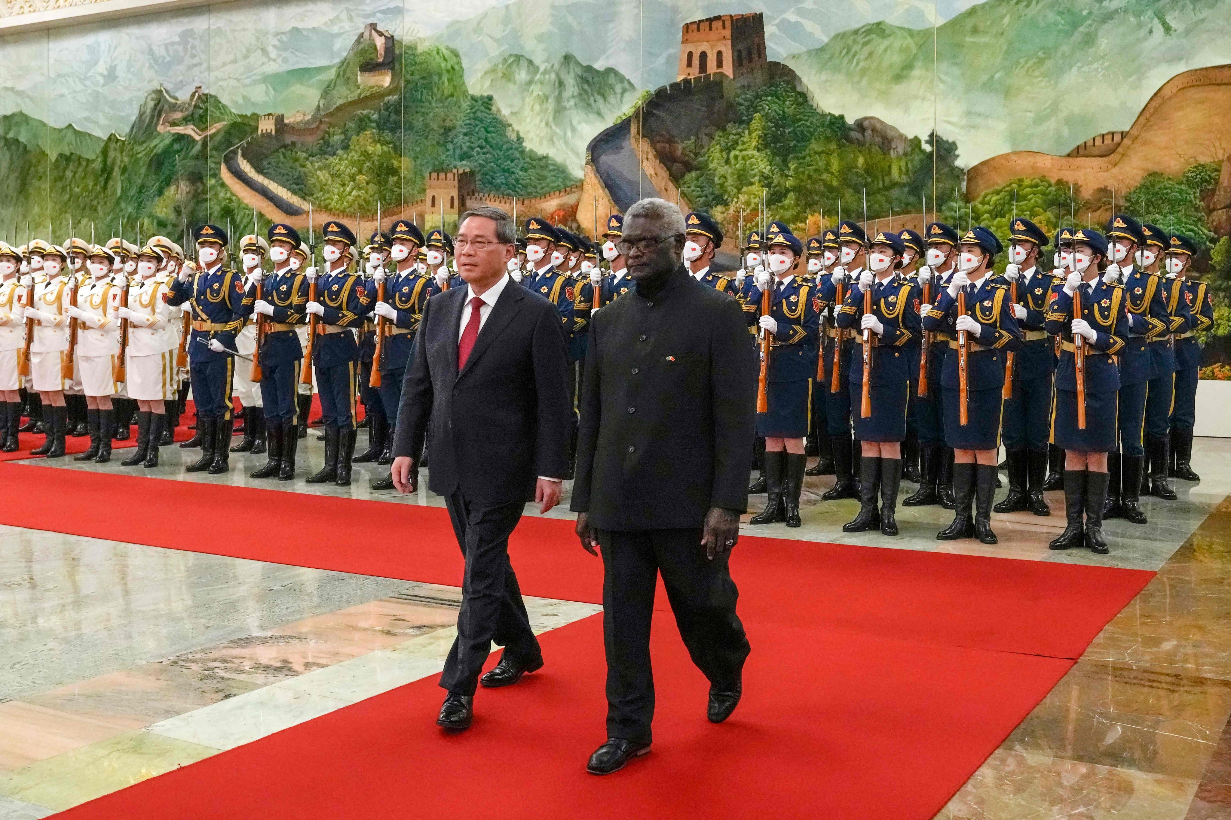 Solomon Islands’ Prime Minister Manasseh Sogavare (right) and China’s Premier Li Qiang inspect a guard of honour during a welcome ceremony at the Great Hall of the People in Beijing in July last year. Photo: AFP